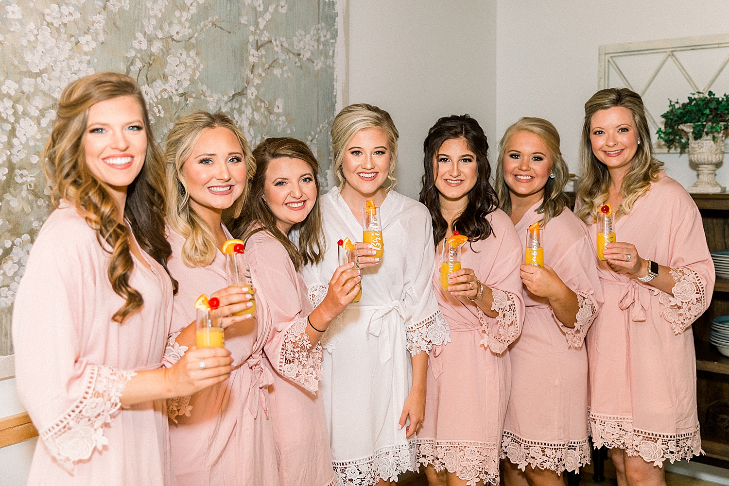 bride and bridesmaids pose in matching robes
