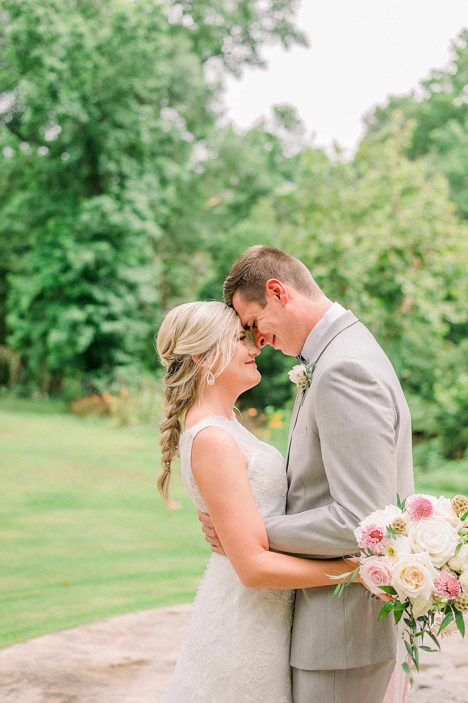 newlyweds touch noses at Creekside Meadows