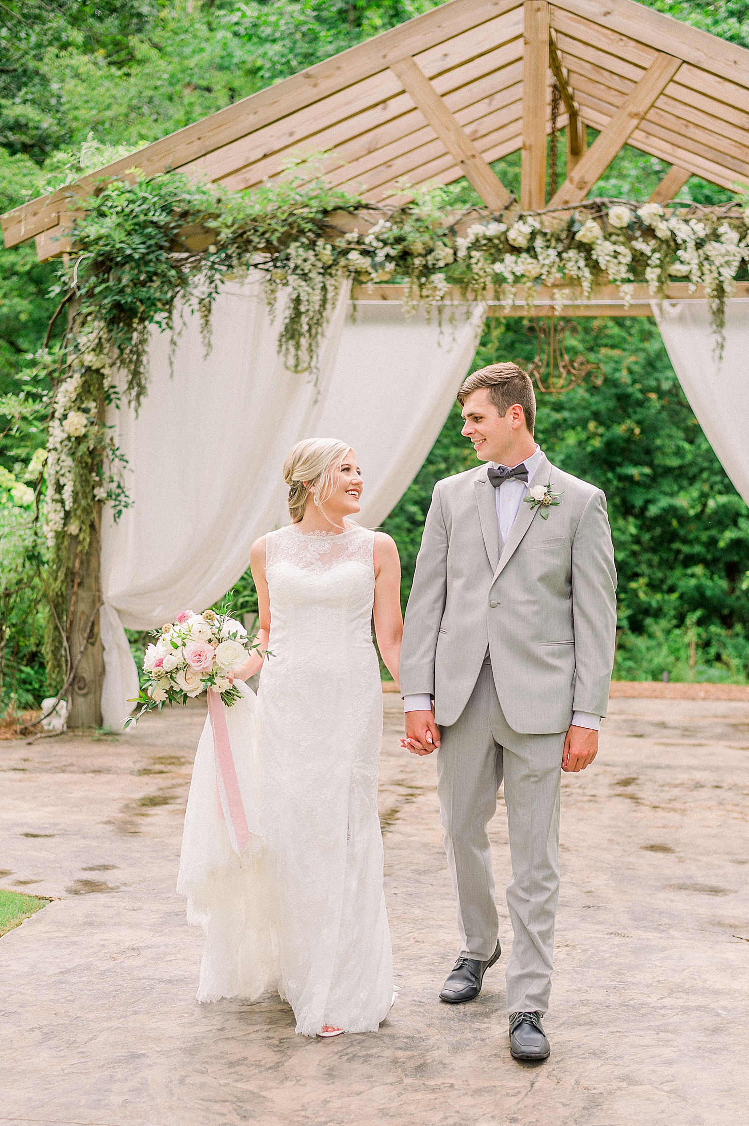 bride and groom walk together around Creekside Meadows