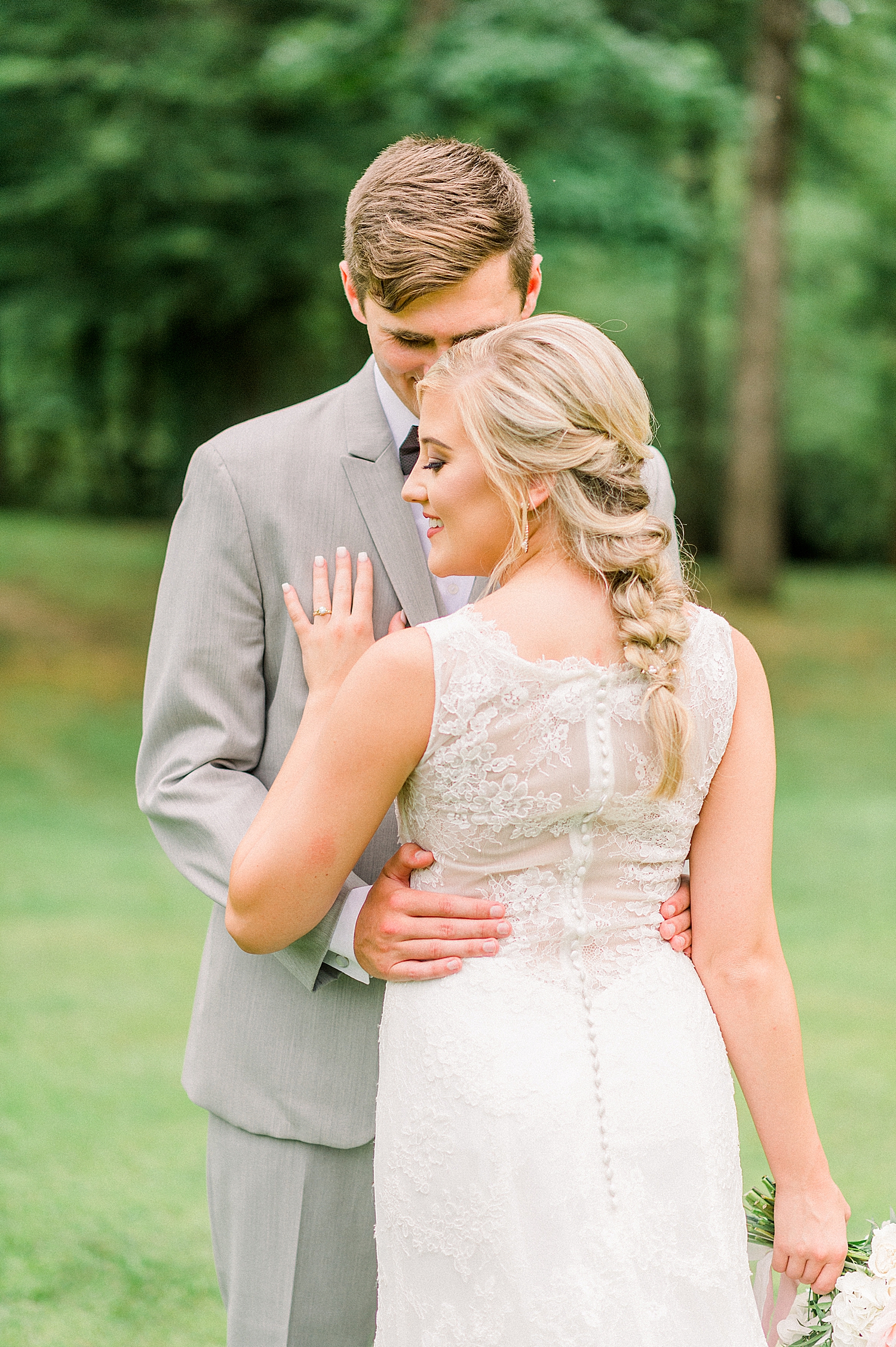 Creekside Meadows wedding portraits with bride showing off lace on wedding gown
