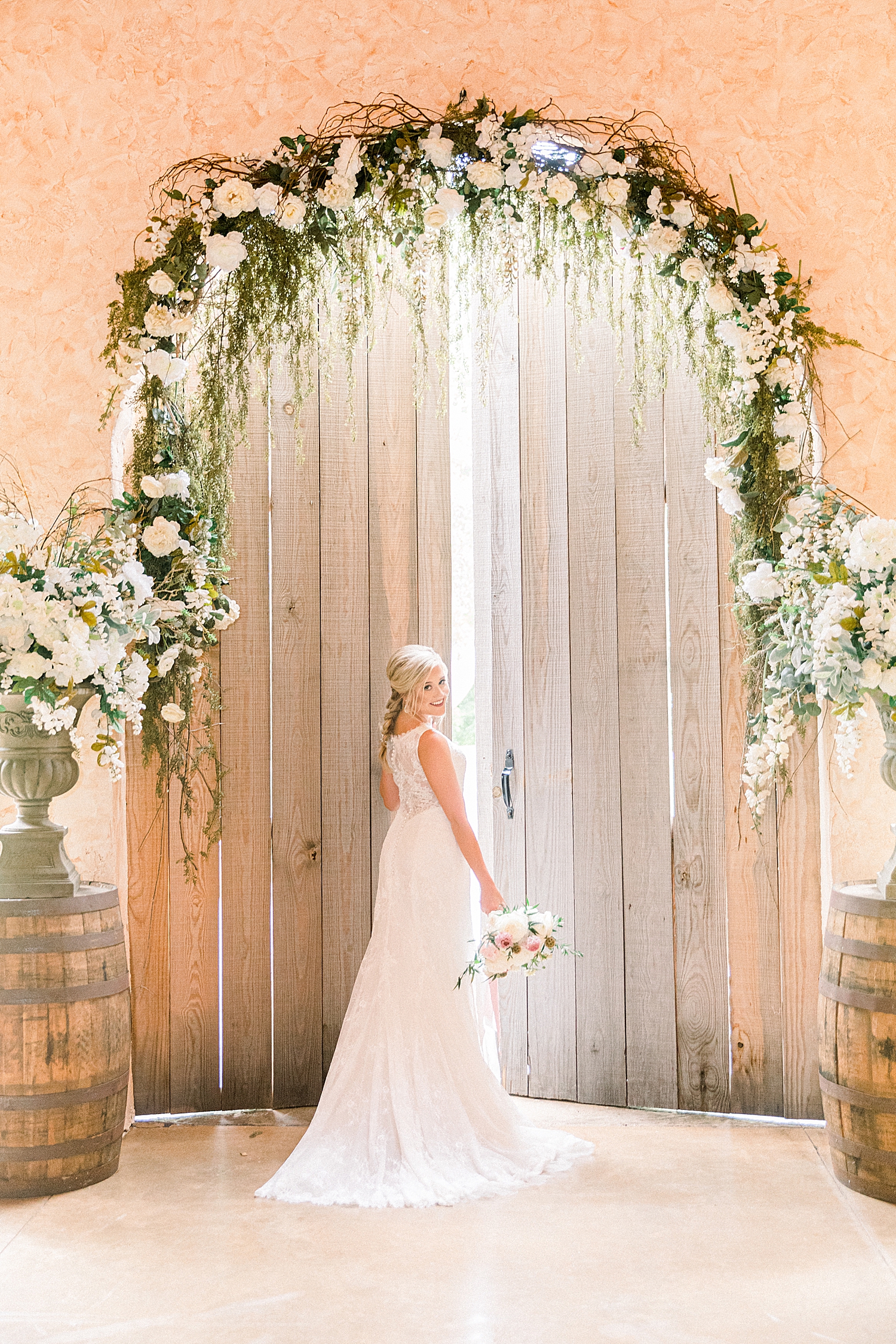bridal portraits by wooden doors at Creekside Meadows