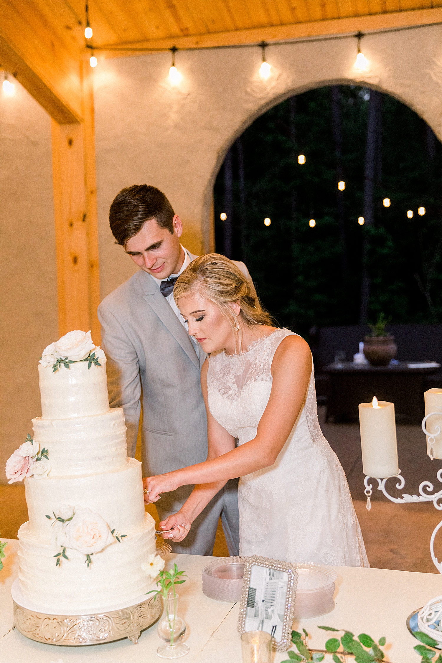 newlyweds cut wedding cake at Birmingham AL wedding reception