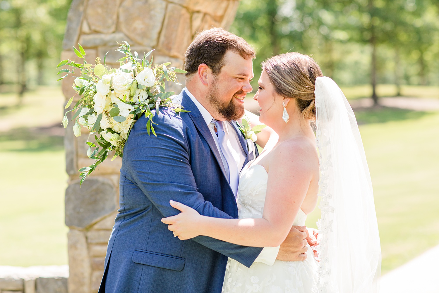 bride and groom pose nose to nose during wedding photos
