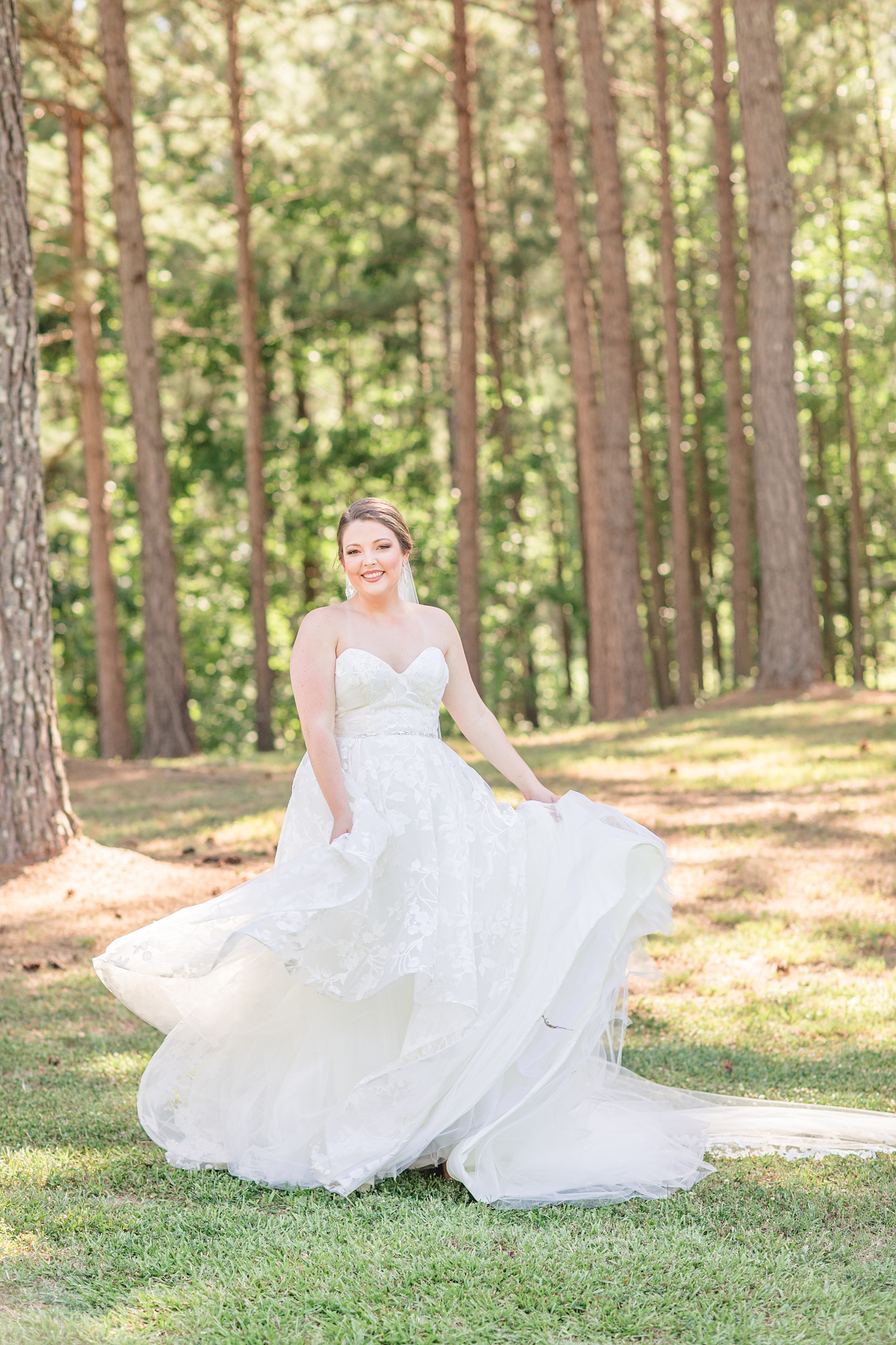 bride twirls wedding gown during bridal portraits in Alabama