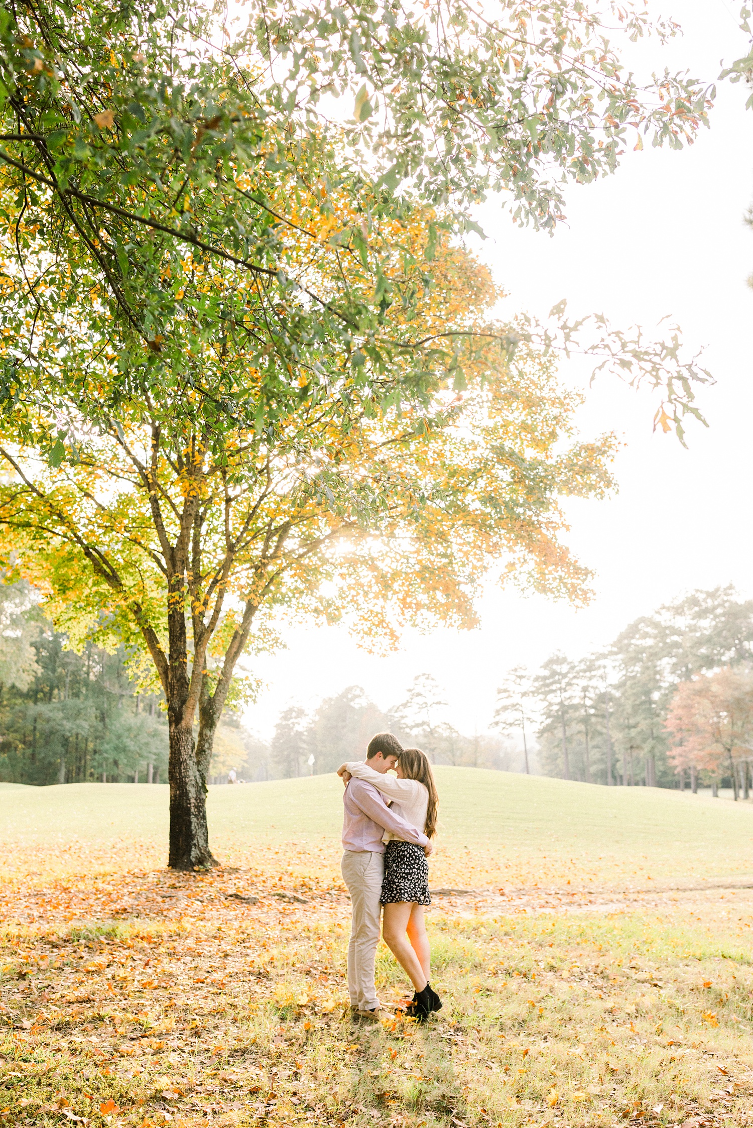 engagement portraits by tall tree at Oak Mountain State Park