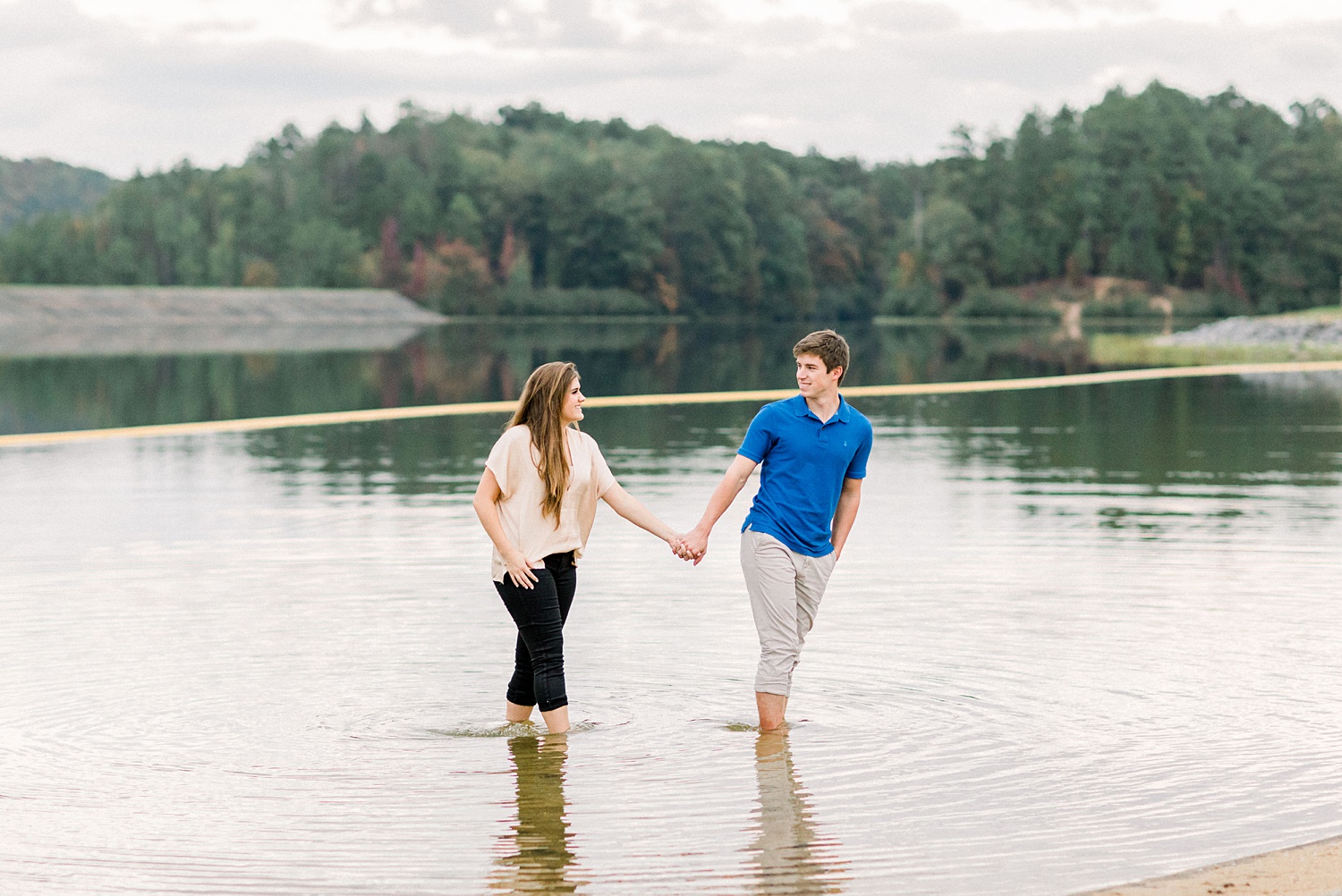 engaged couple walks through water at Oak Mountain State Park