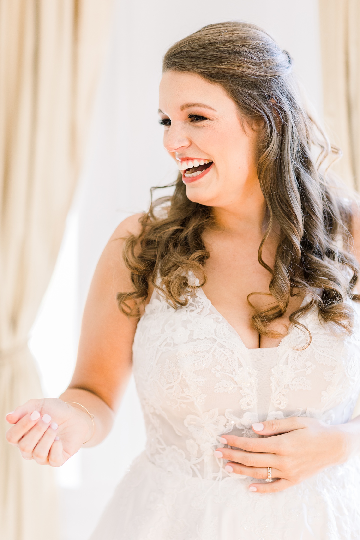 bride laughs during wedding morning prep