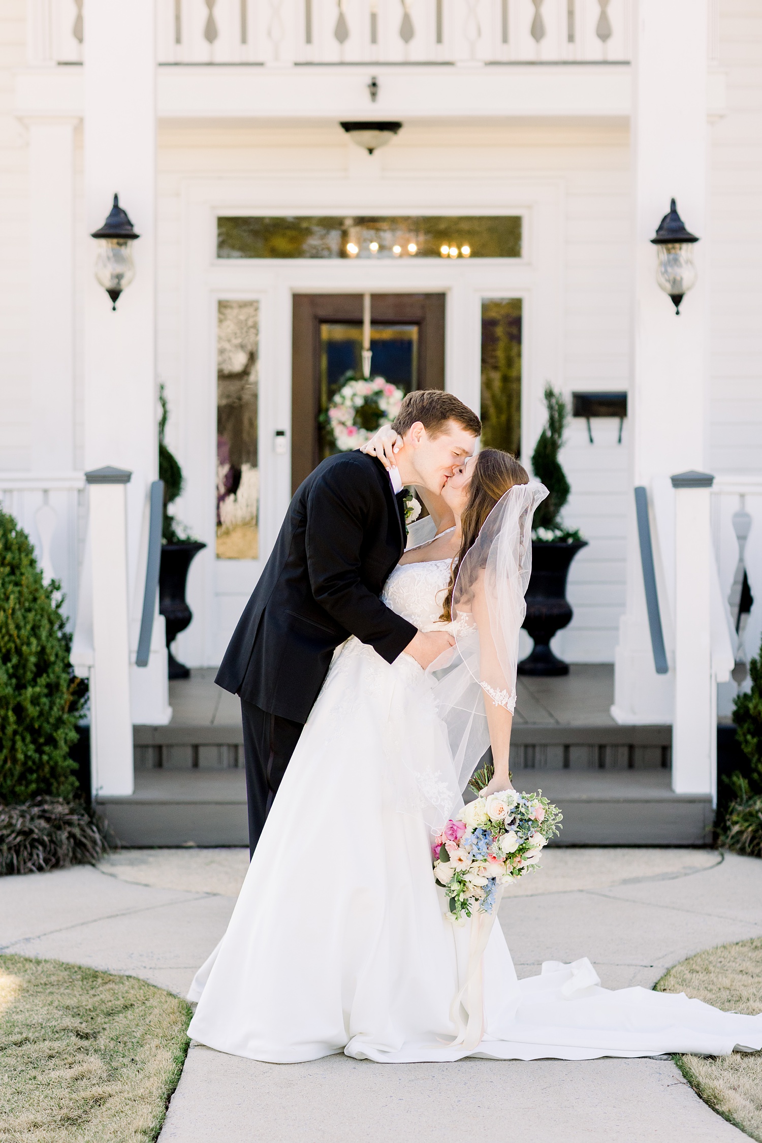 newlyweds kiss outside Camelot Manor
