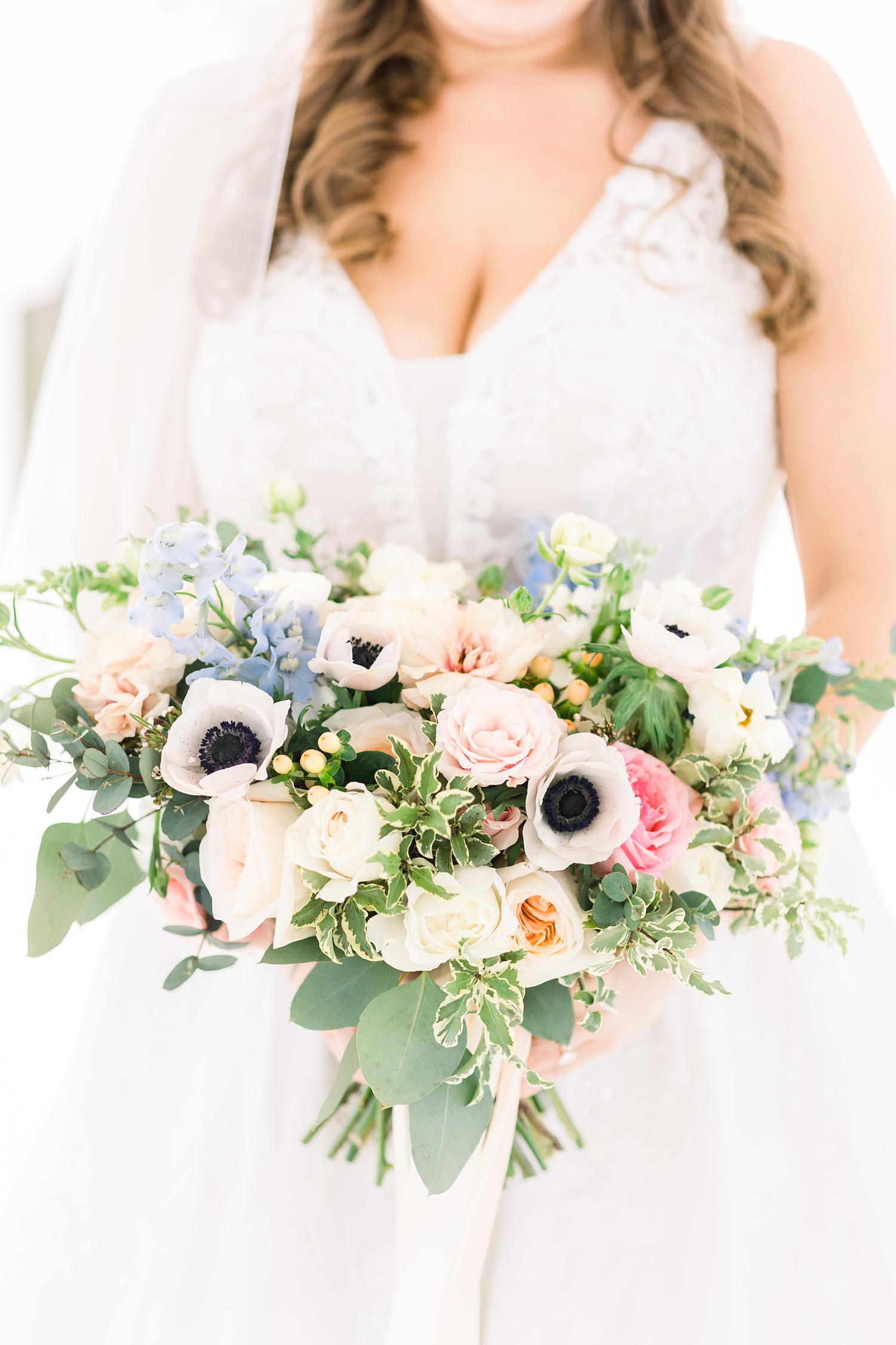 bride holds bouquet of winter flowers