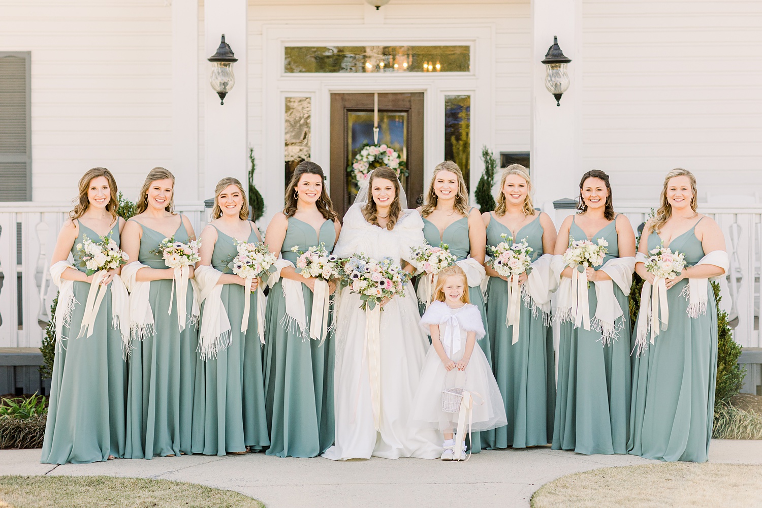 bride poses with bridesmaids outside Camelot Manor