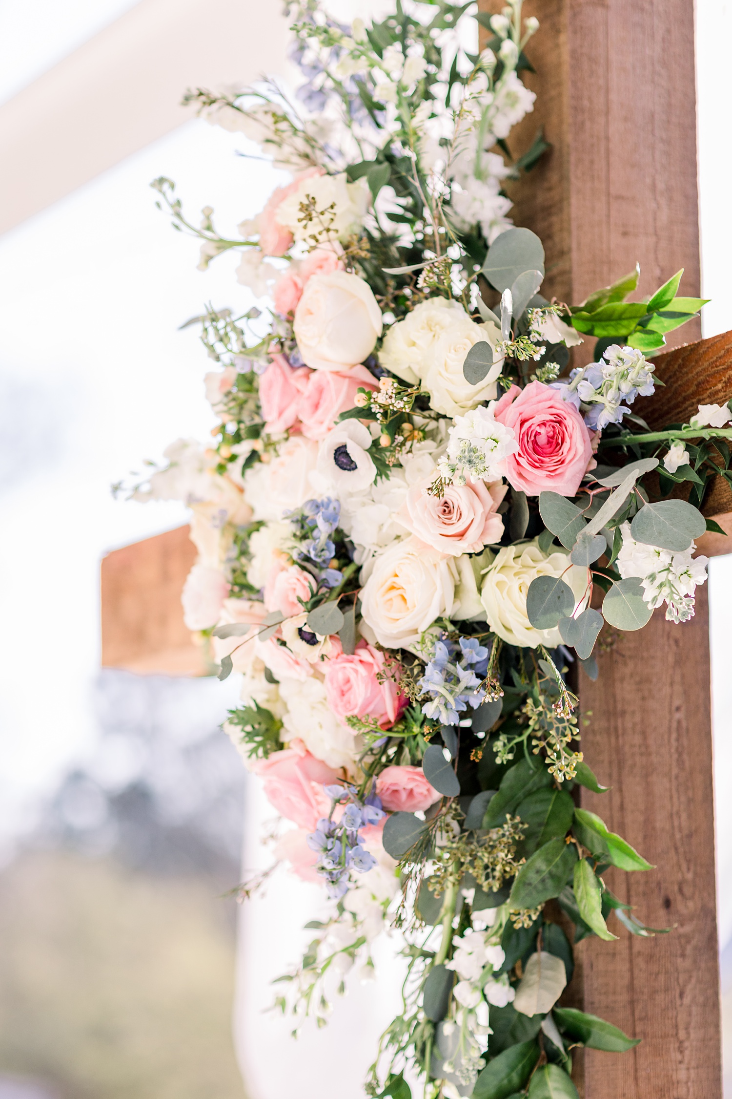 wooden cross with floral decor at Camelot Manor