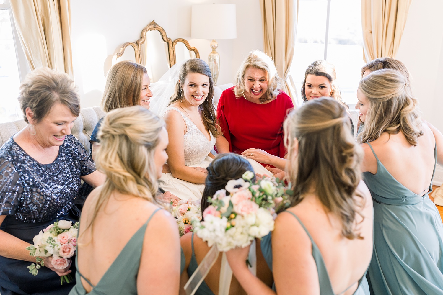bride prays with women before wedding ceremony at Camelot Manor