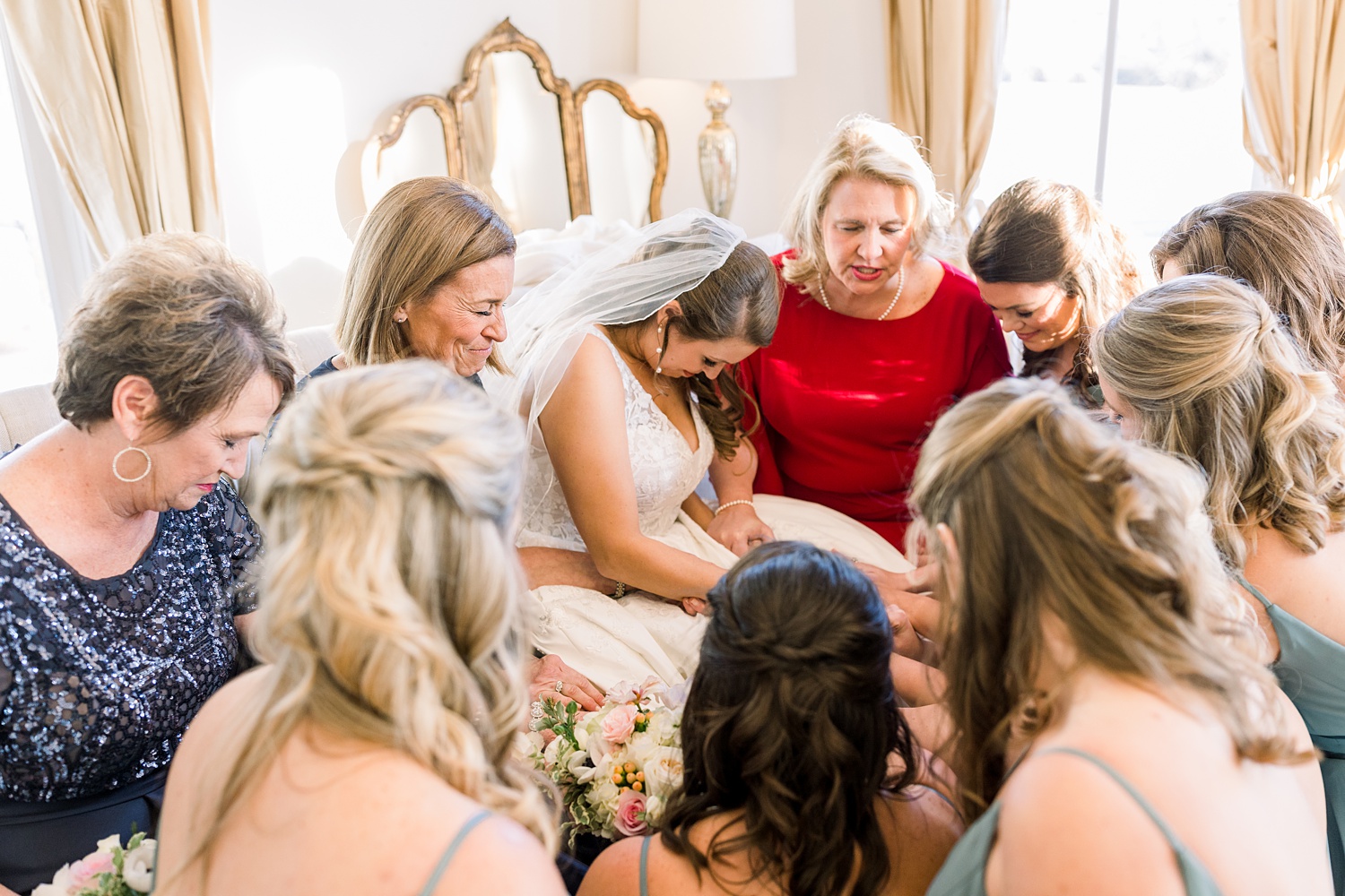 bride and bridesmaids pray before wedding ceremony in Alabama
