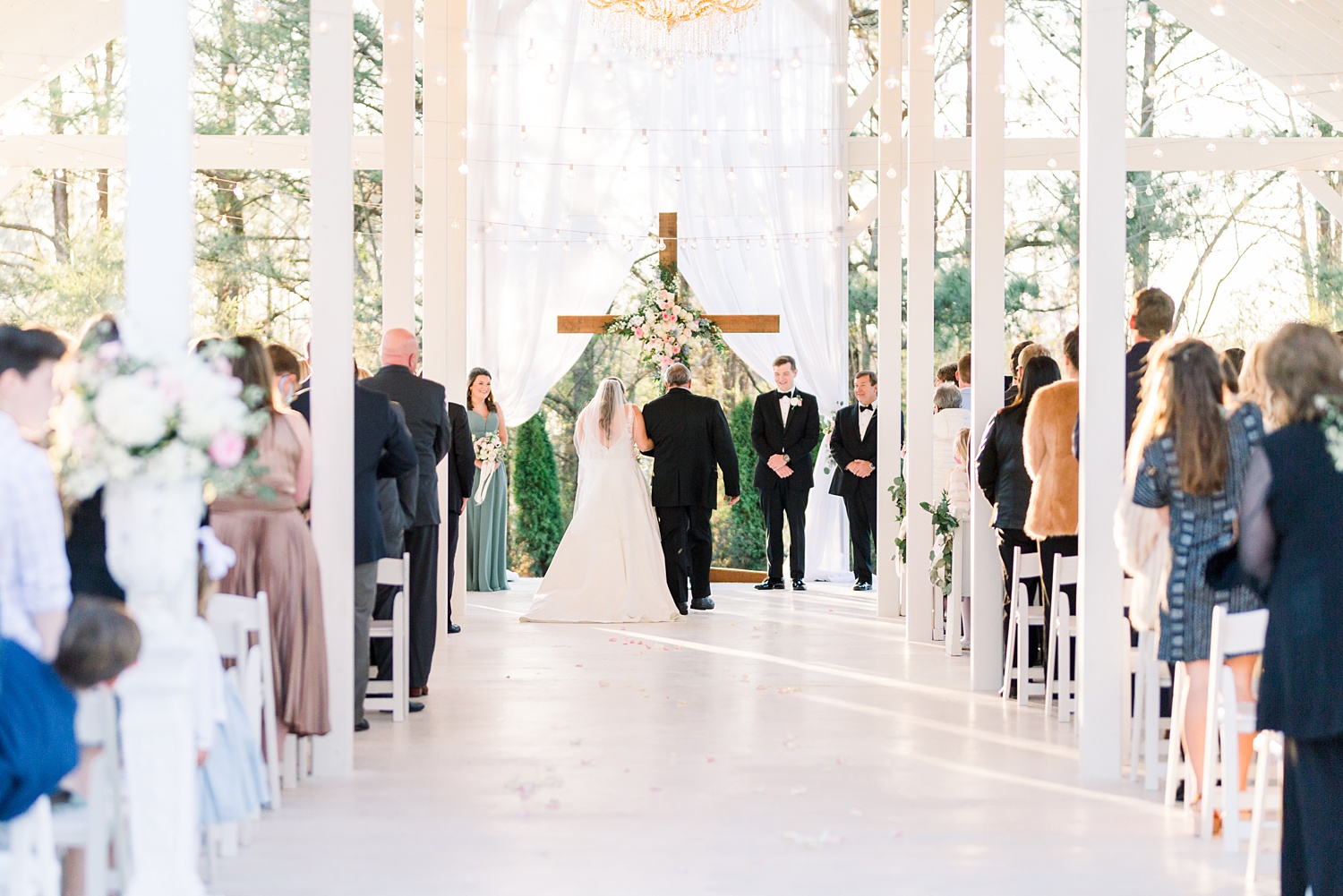 Camelot Manor wedding ceremony outside with wooden cross