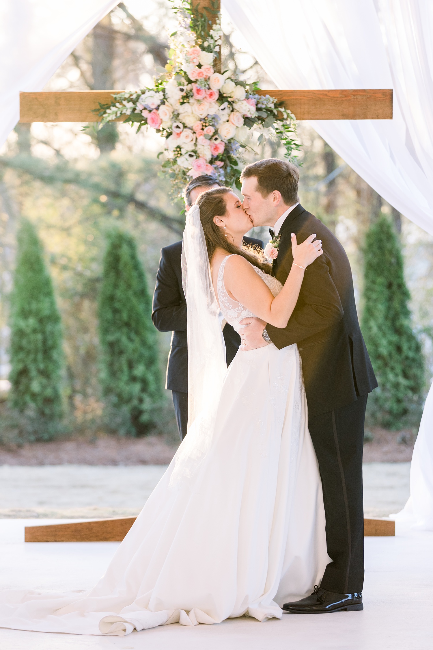 newlyweds kiss during Camelot Manor wedding ceremony