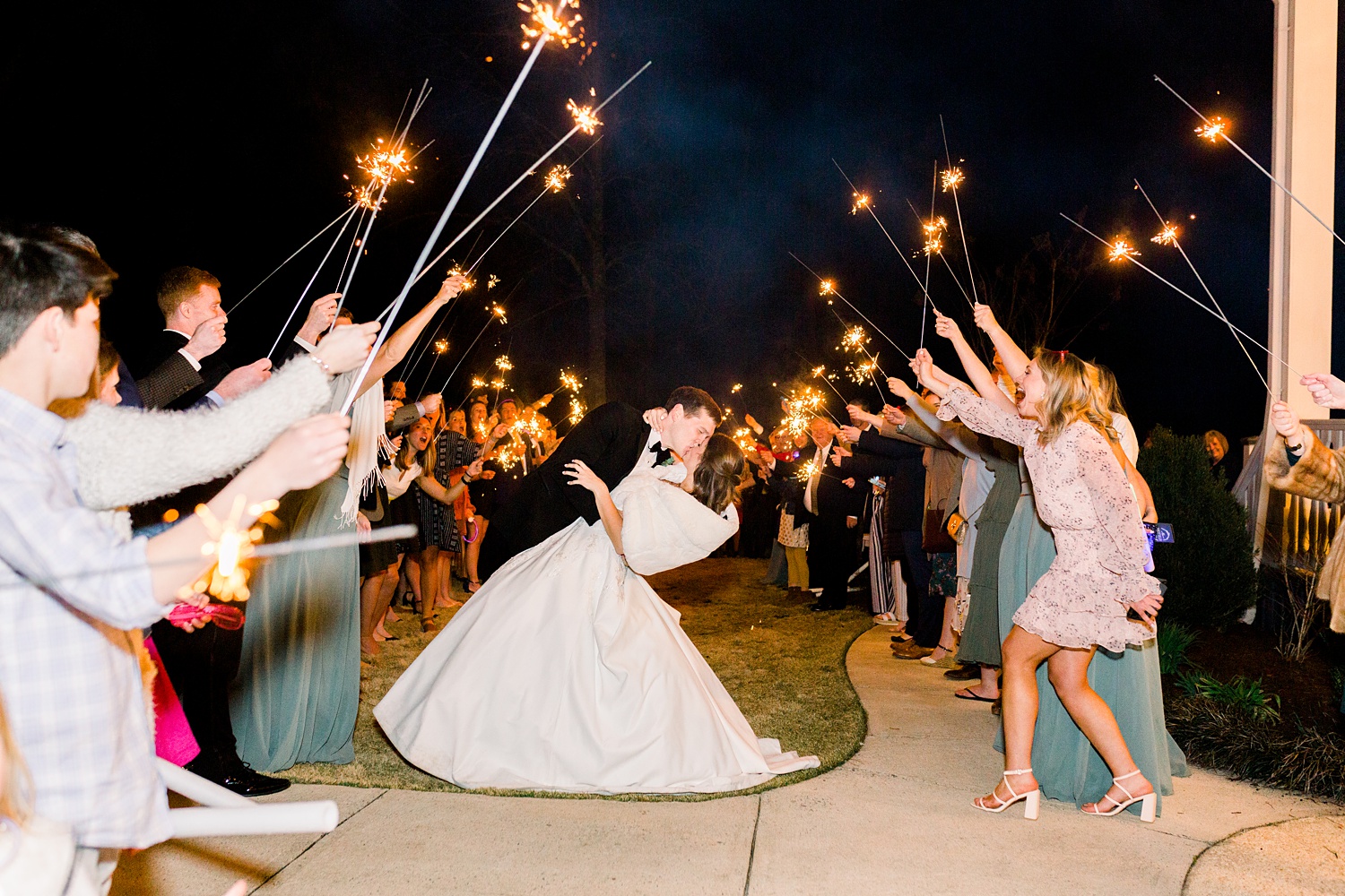 newlyweds kiss during sparkler exit from Alabama wedding reception