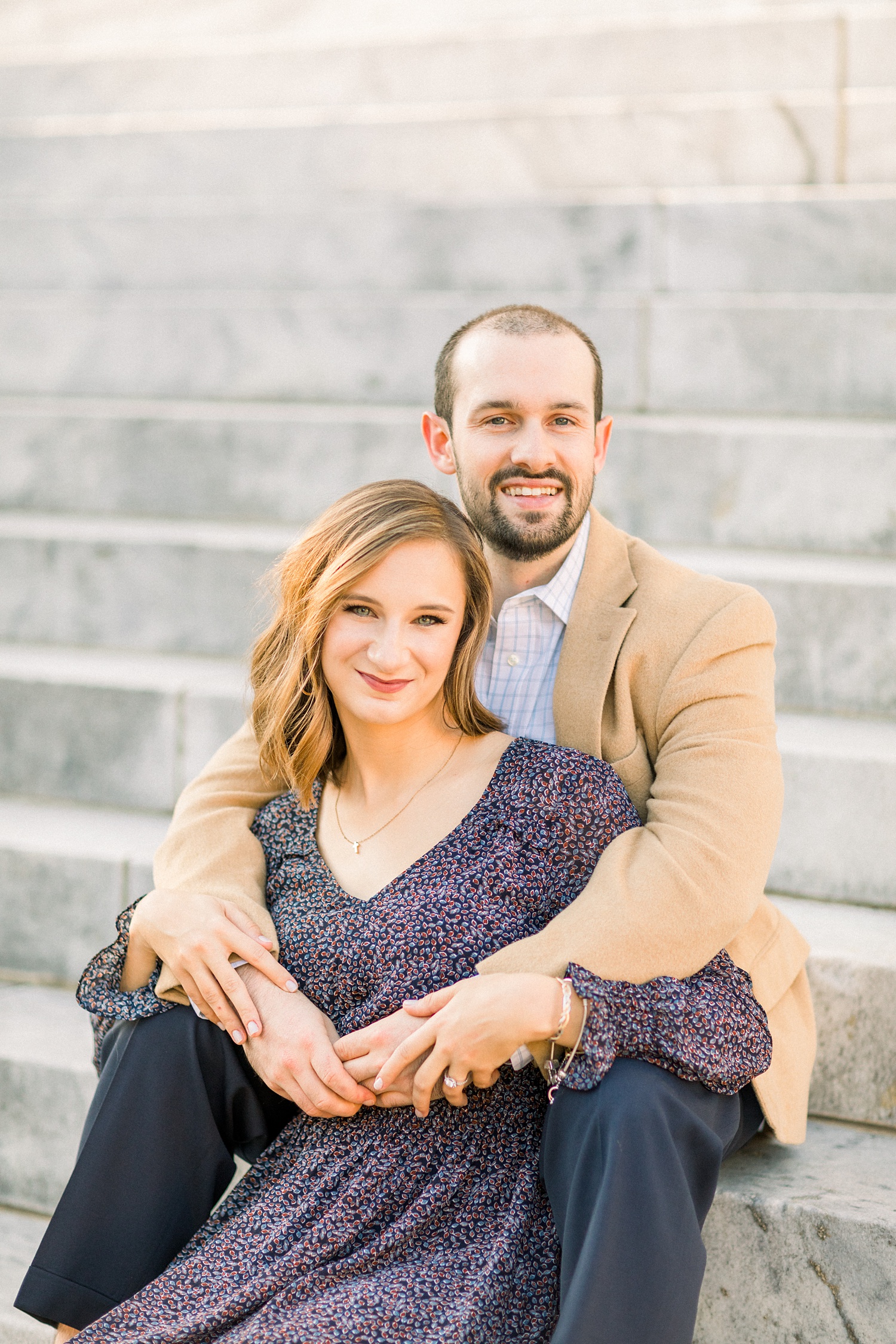 bride and groom sit on steps during Downtown Birmingham engagement session