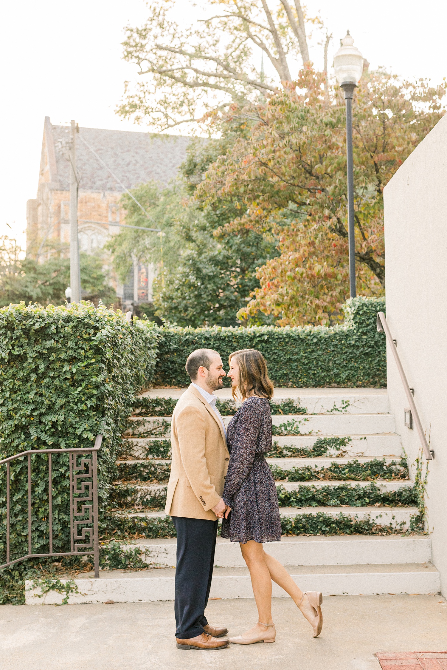 bride and groom pose on ivy covered steps