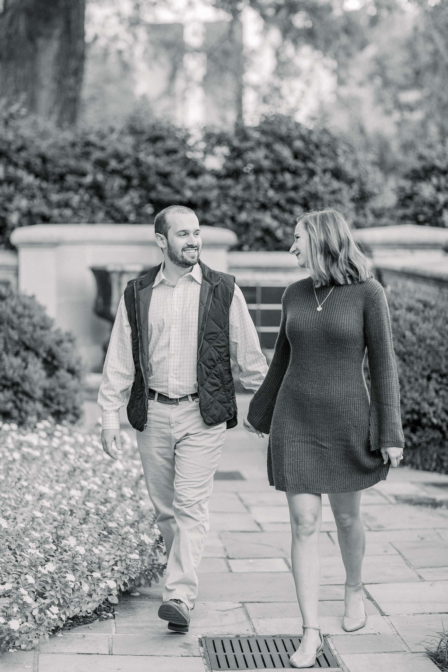 engaged couple walks through gardens of Downtown Birmingham