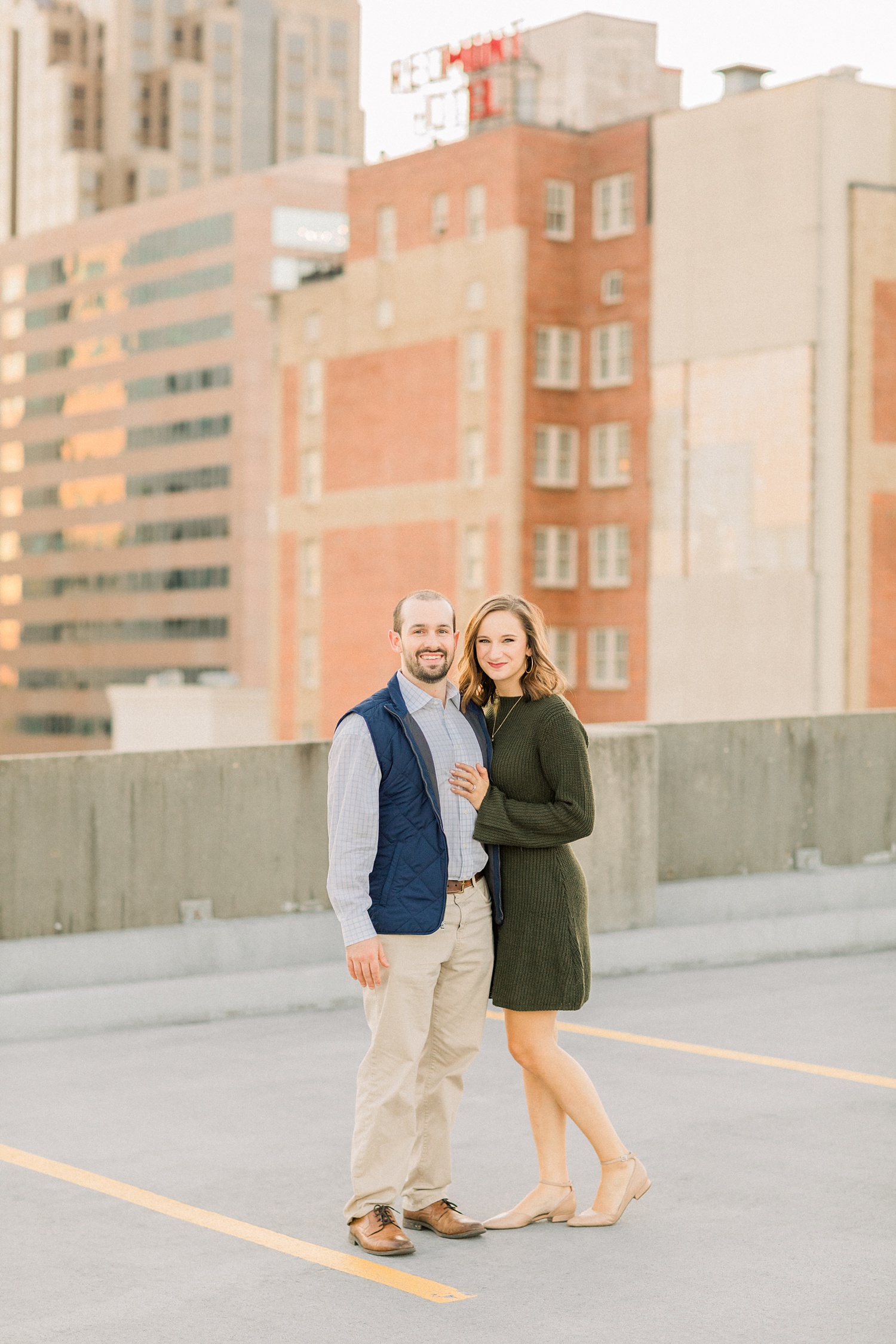 couple poses on top of parking garage in Alabama