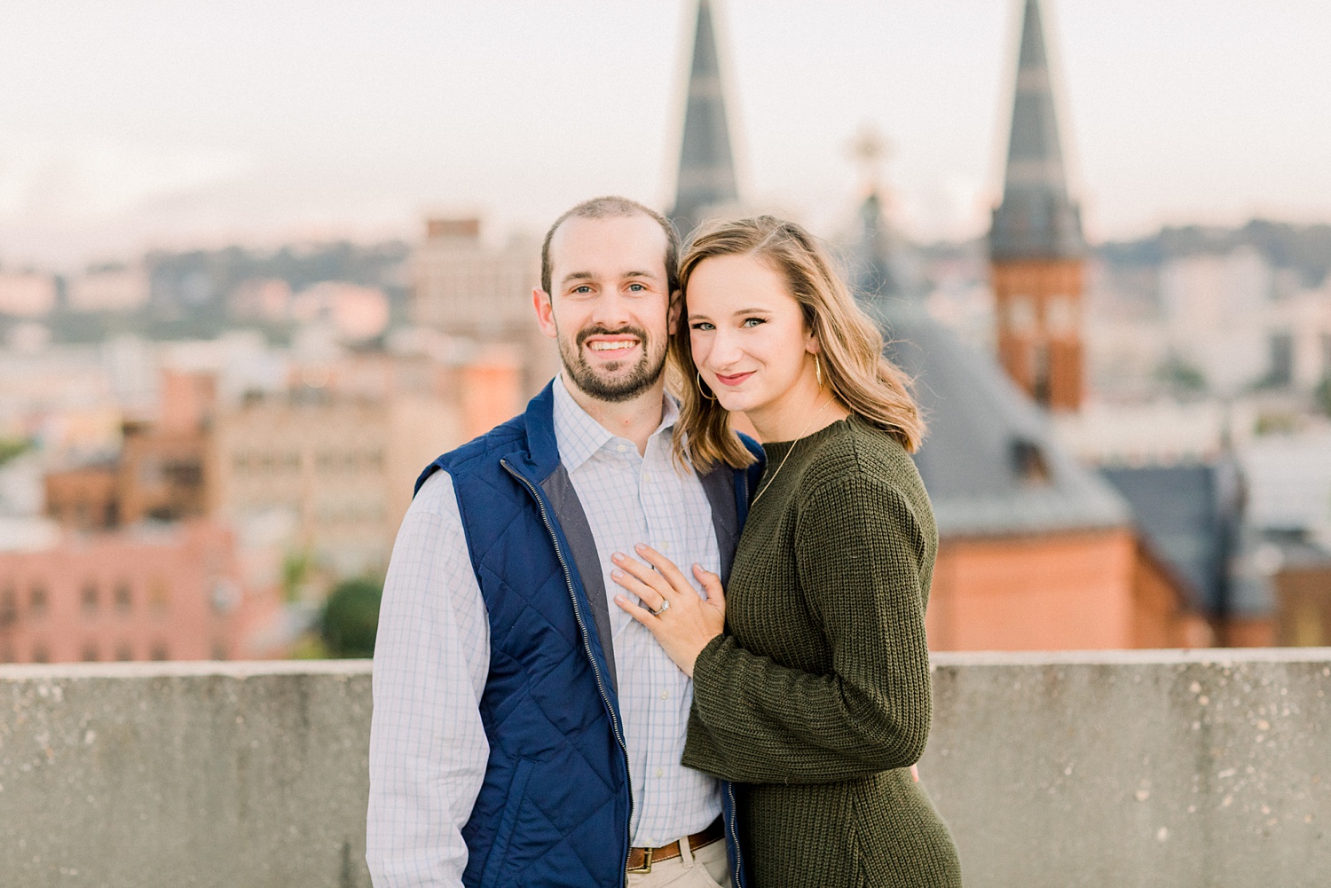 couple poses on rooftop in Downtown Birmingham