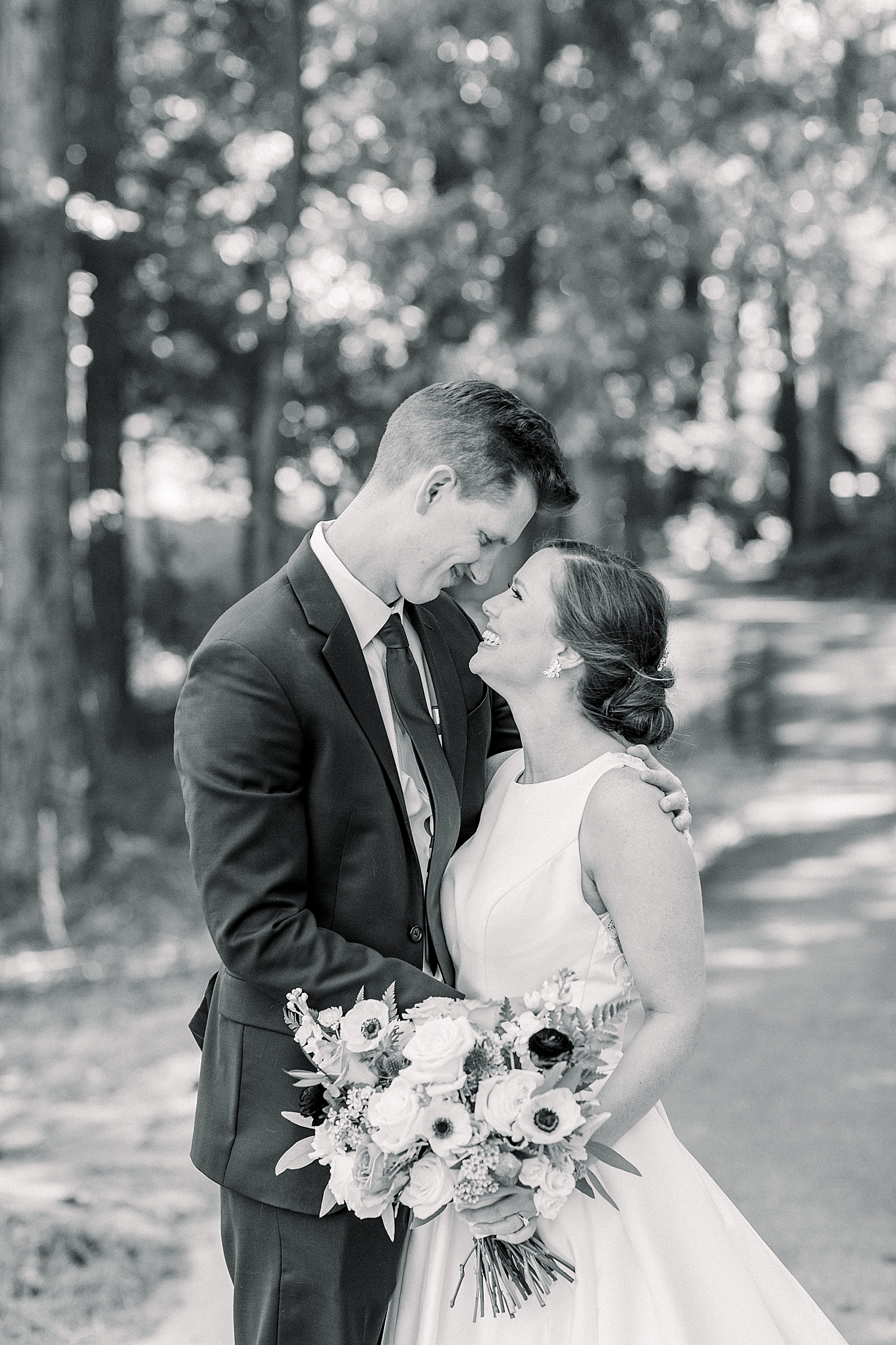 bride and groom nuzzle noses during first look
