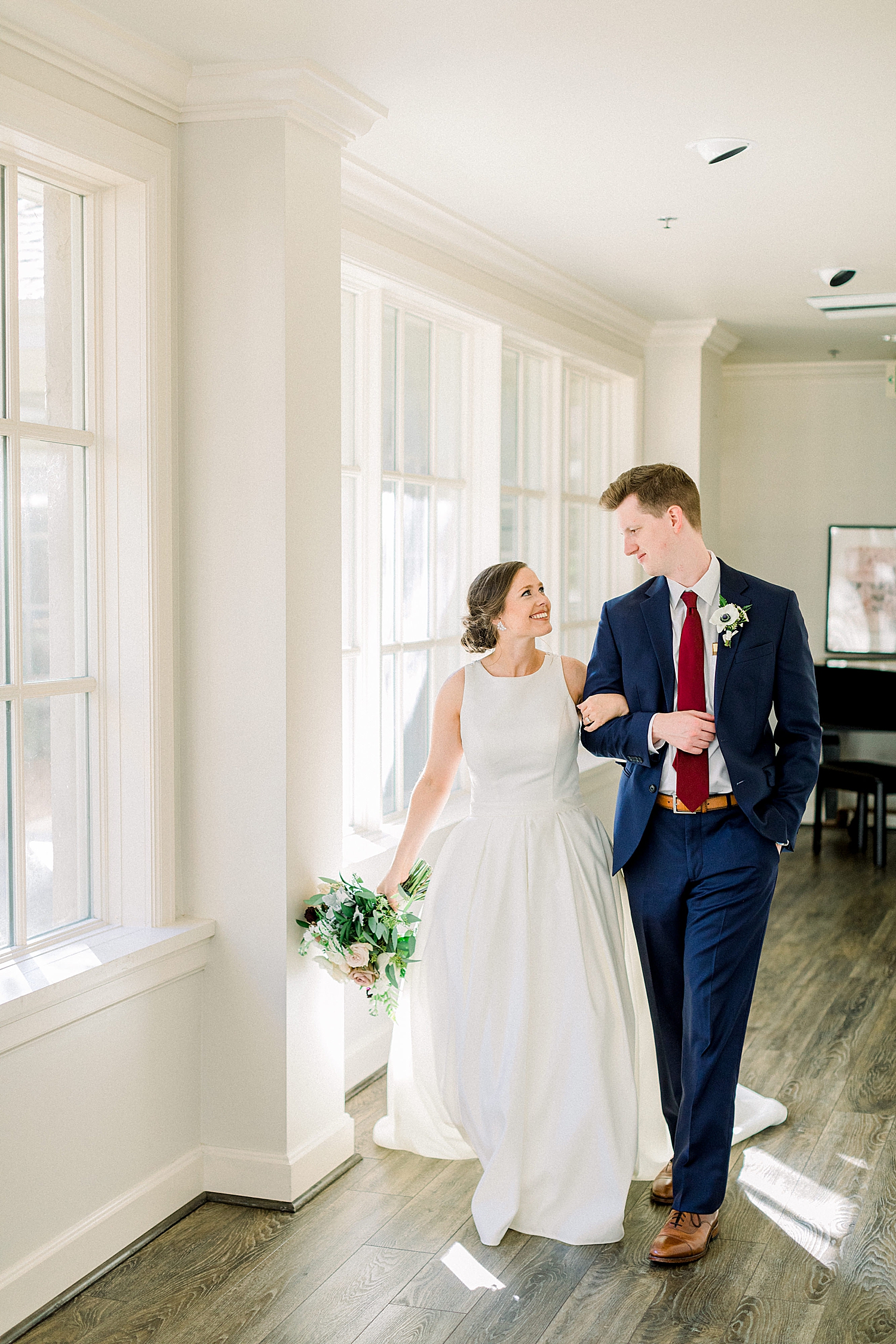 bride and groom walk through lobby at Riverchase Country Club