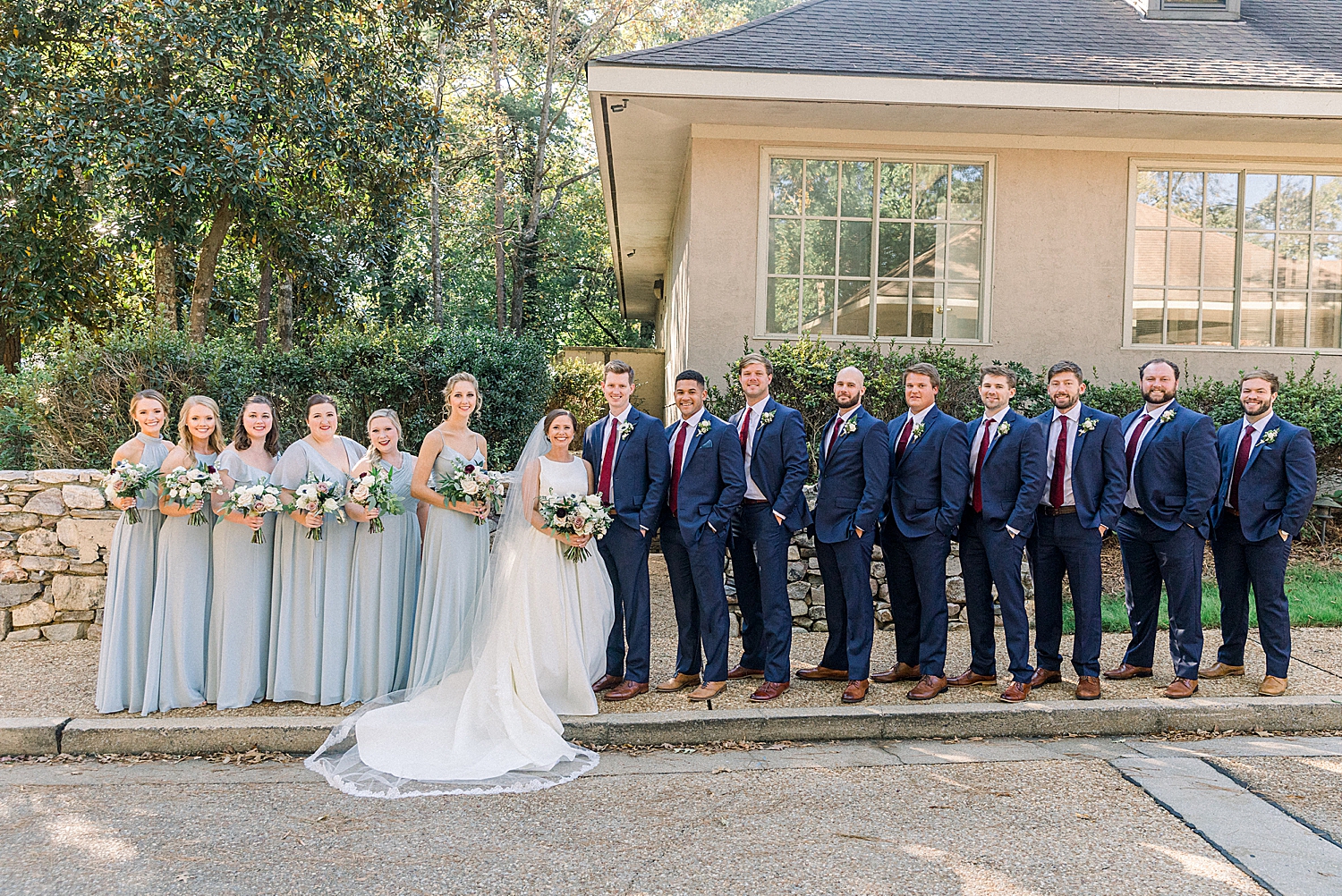 bride and groom pose with wedding party at Riverchase Country Club