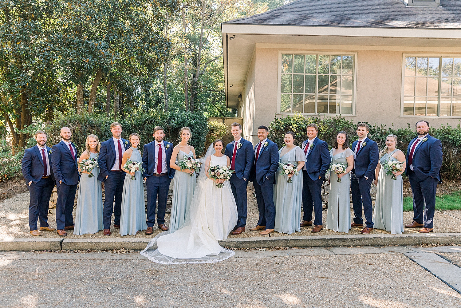 bride and groom pose with full bridal party