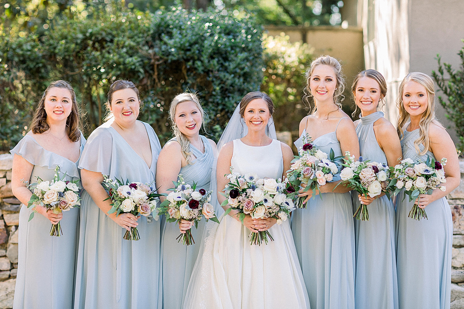 bride and bridesmaids pose outside Riverchase Country Club
