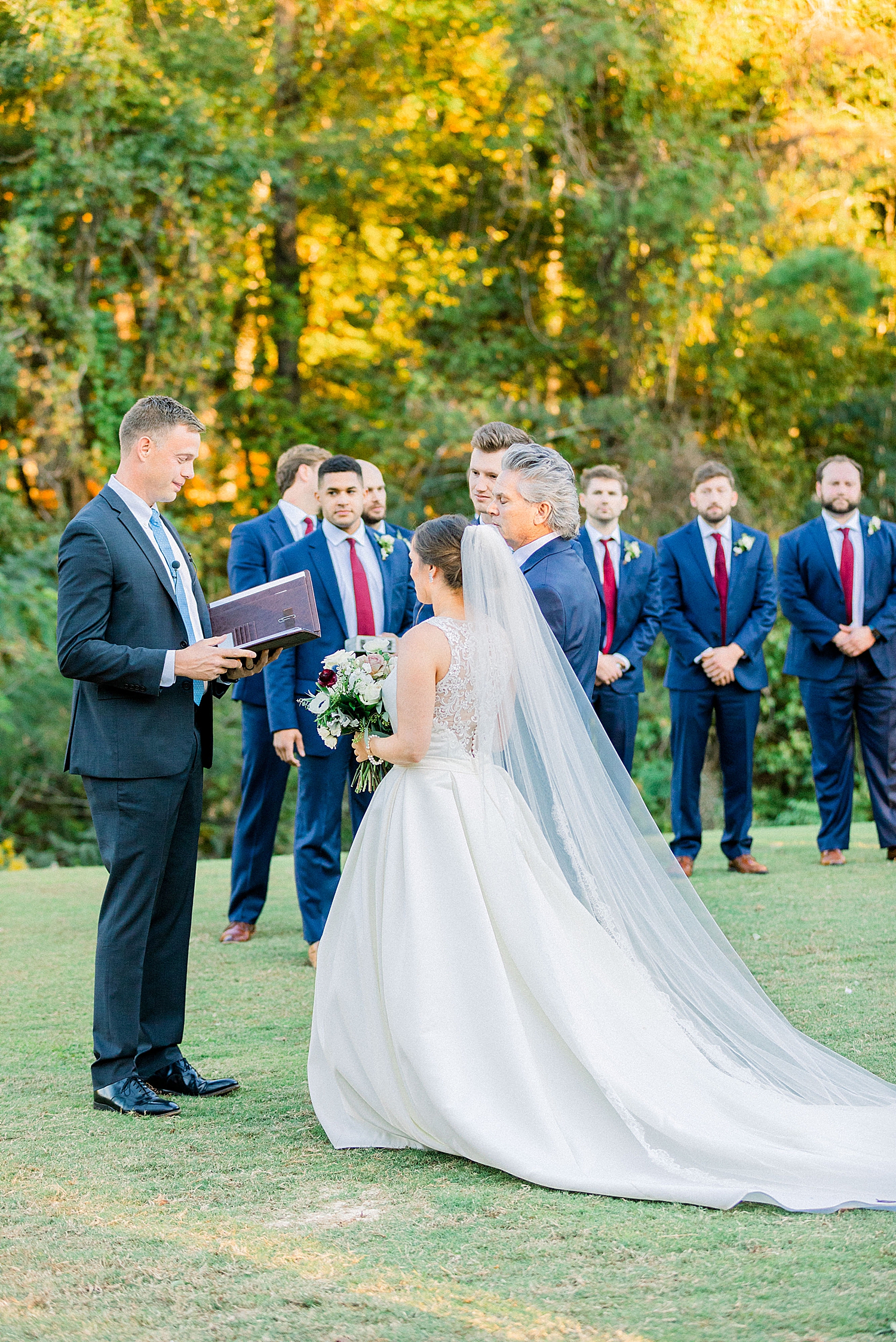 Riverchase Country Club fall wedding ceremony outdoors with floral arbor