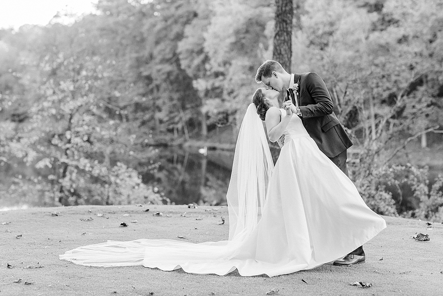 Riverchase Country Club wedding portraits with bride and groom kissing