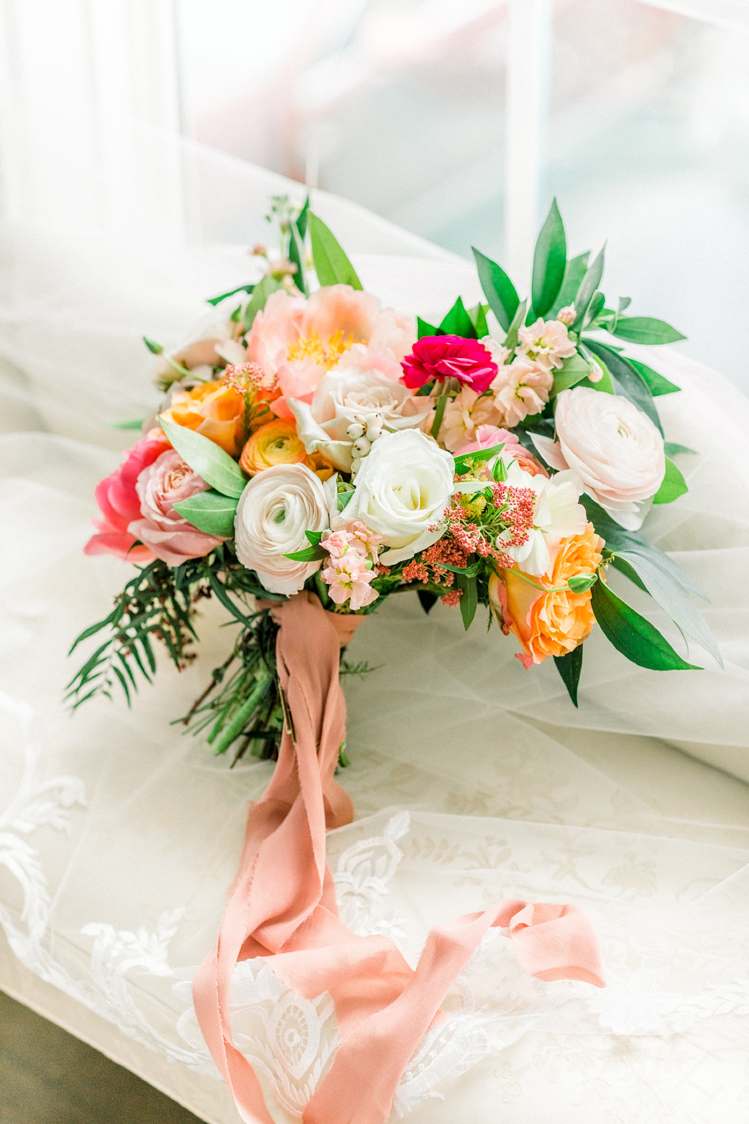bright wedding bouquet with cascading pink ribbon