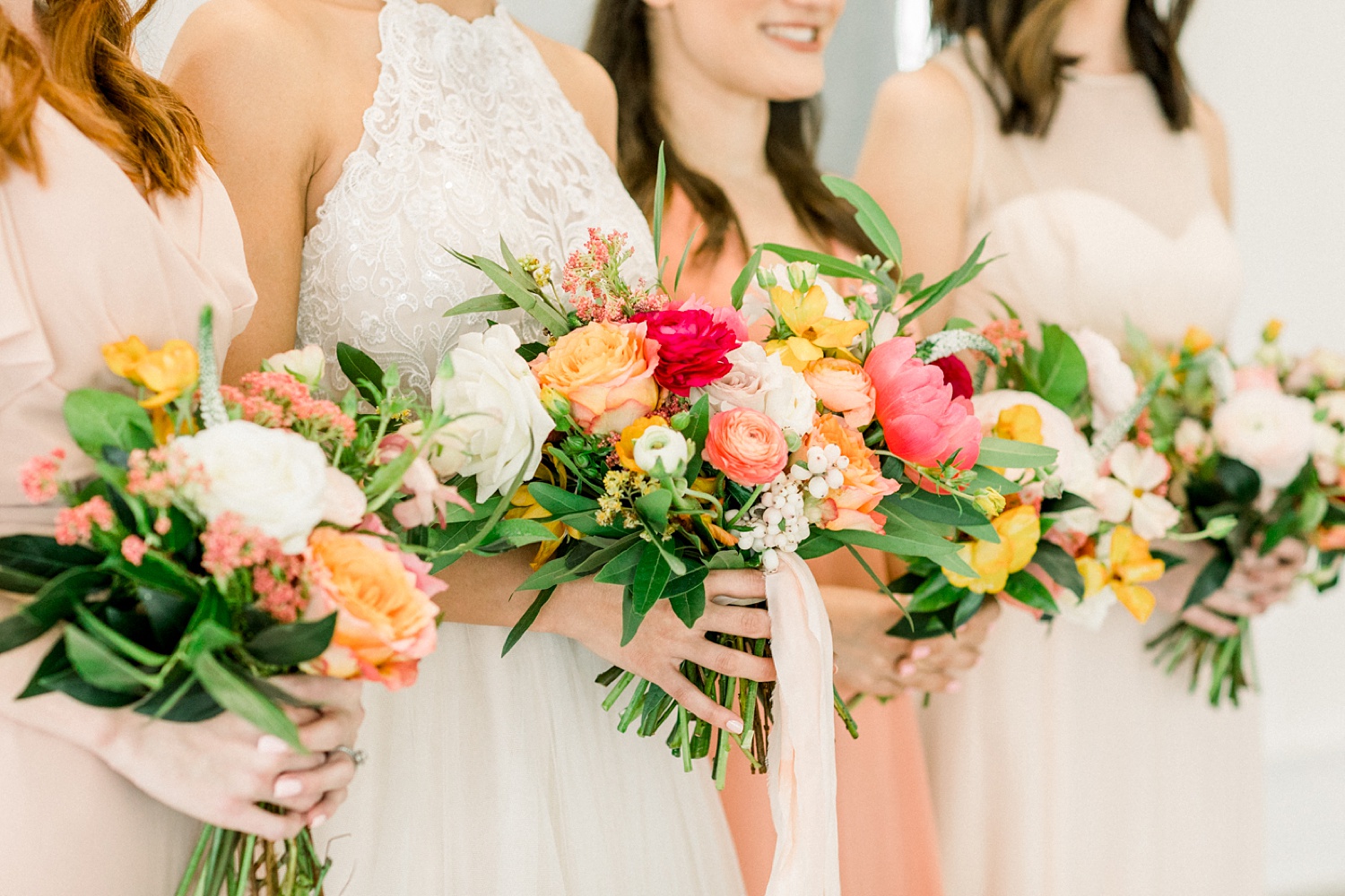 spring wedding inspiration with peach and pink bouquets