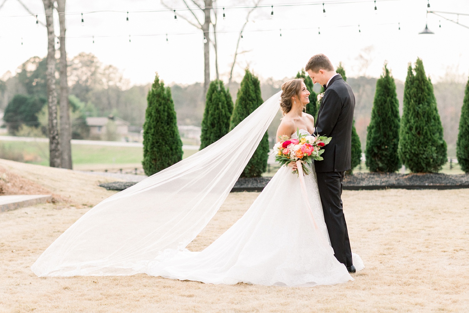 Oak Meadow Event Center wedding portraits with bride's veil floating