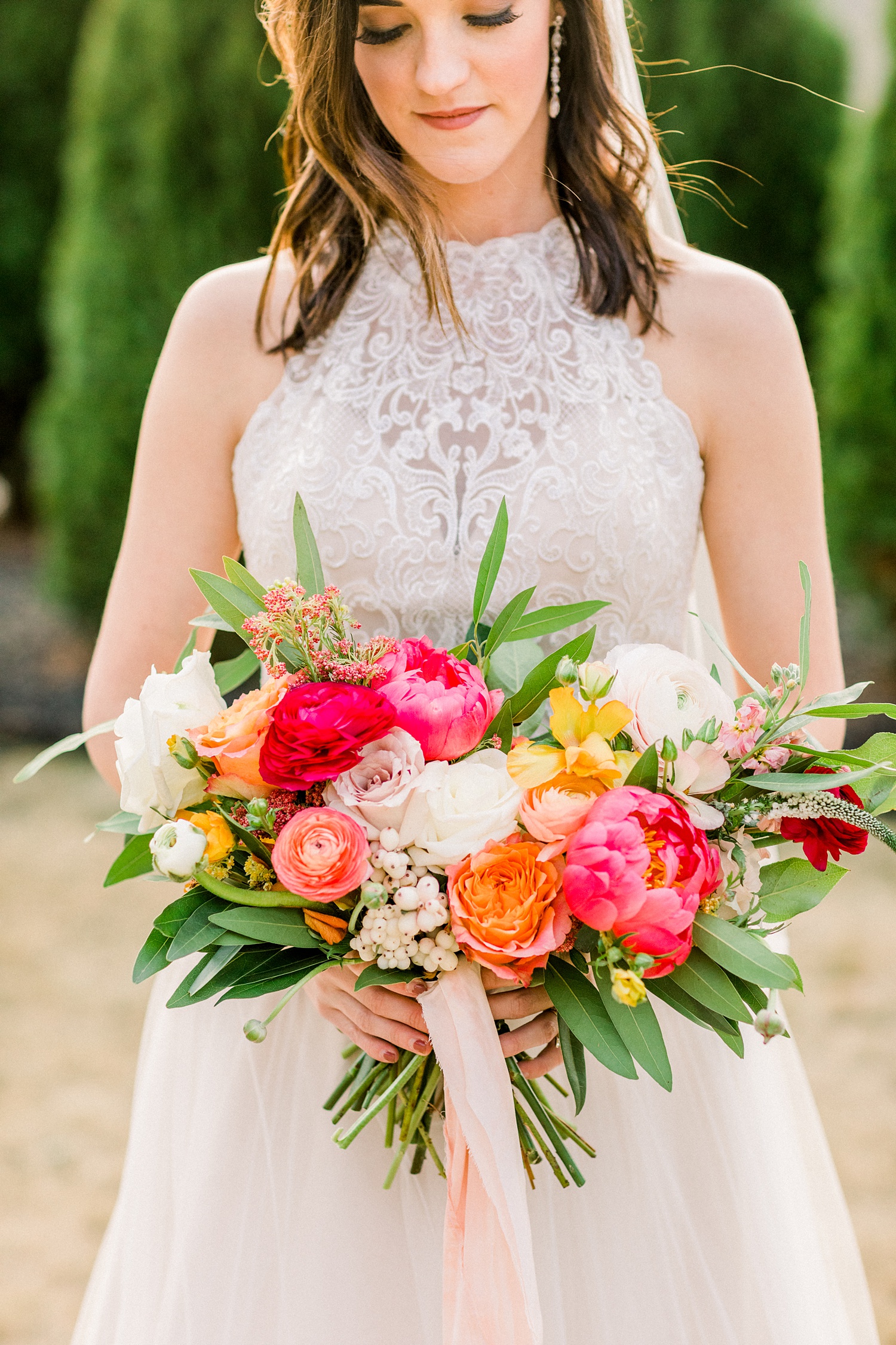 Oak Meadow Event Center bridal portraits with pink and orange bouquet
