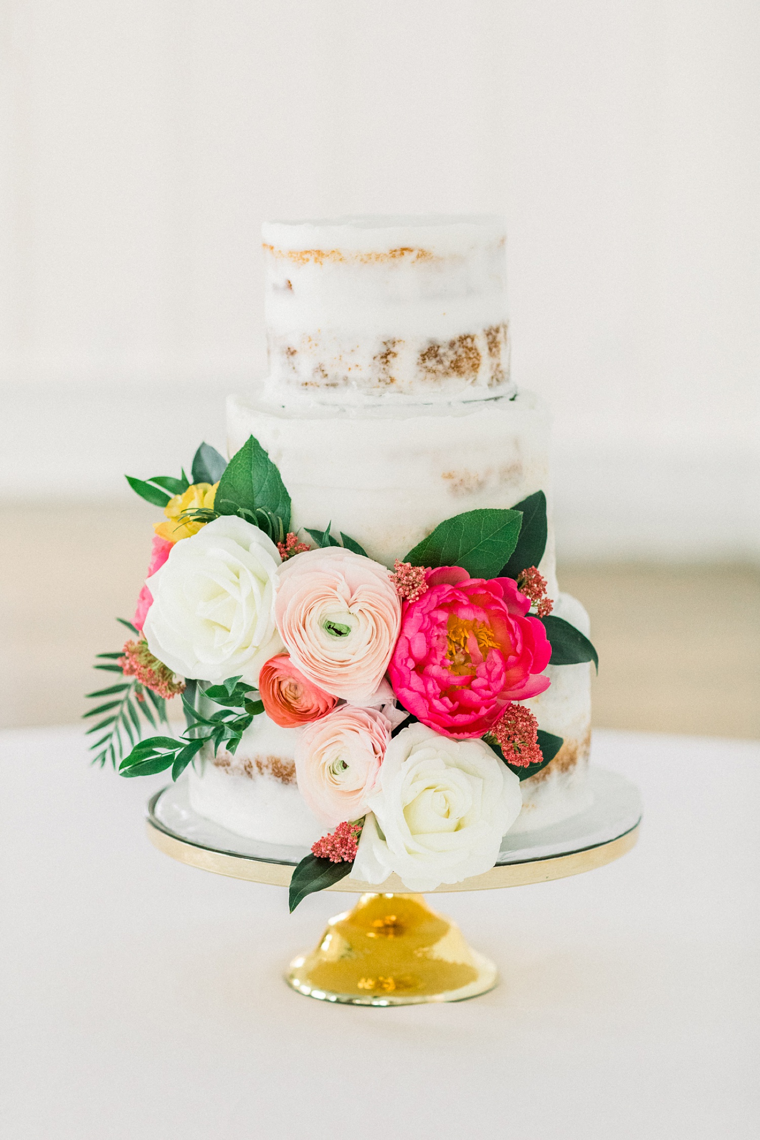 tiered naked wedding cake with florals