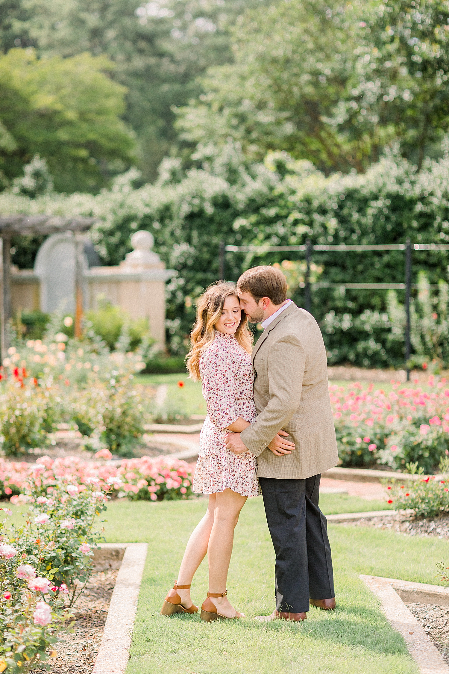 Alabama couple hugs in rose garden at Birmingham Botanical Gardens