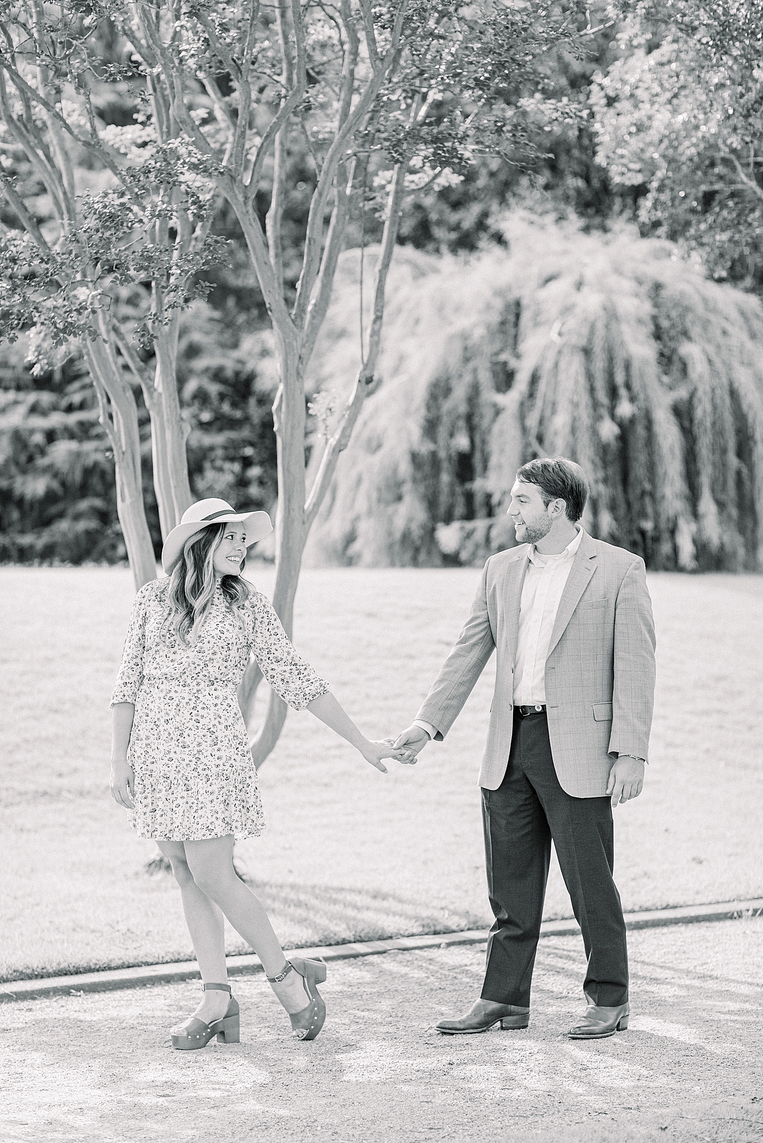 black and white portrait of couple walking through Birmingham Botanical Gardens