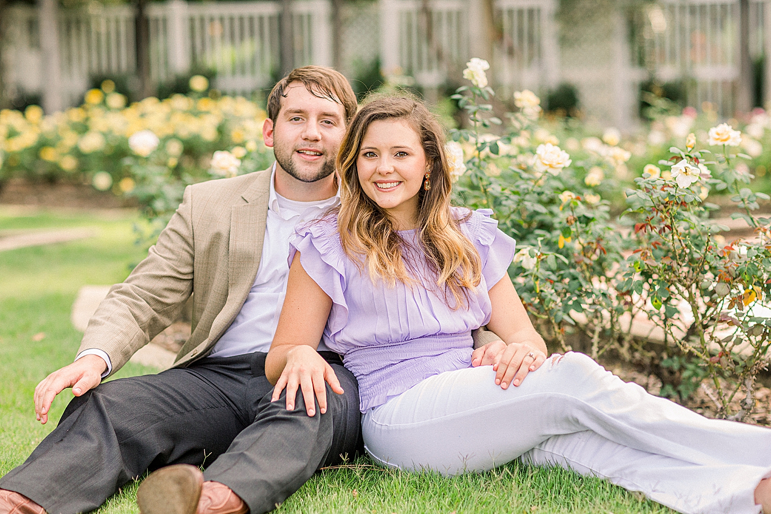 bride and groom sit in flower gardens in Alabama