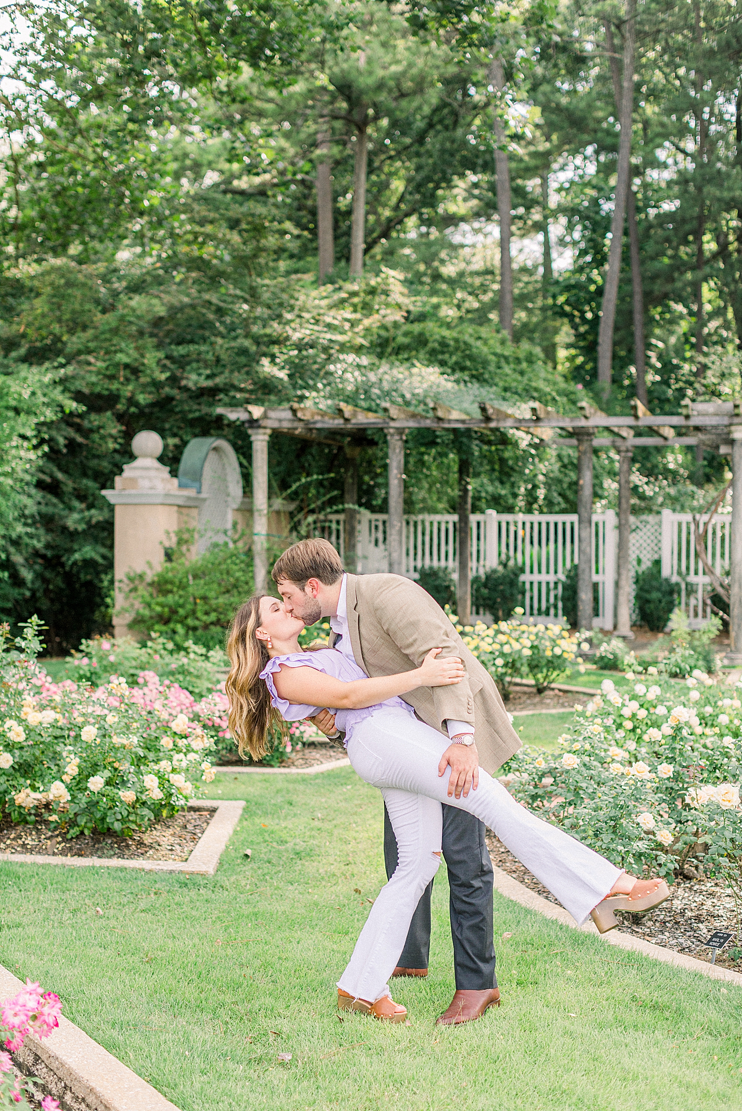 engaged couple kisses in Birmingham Botanical Gardens