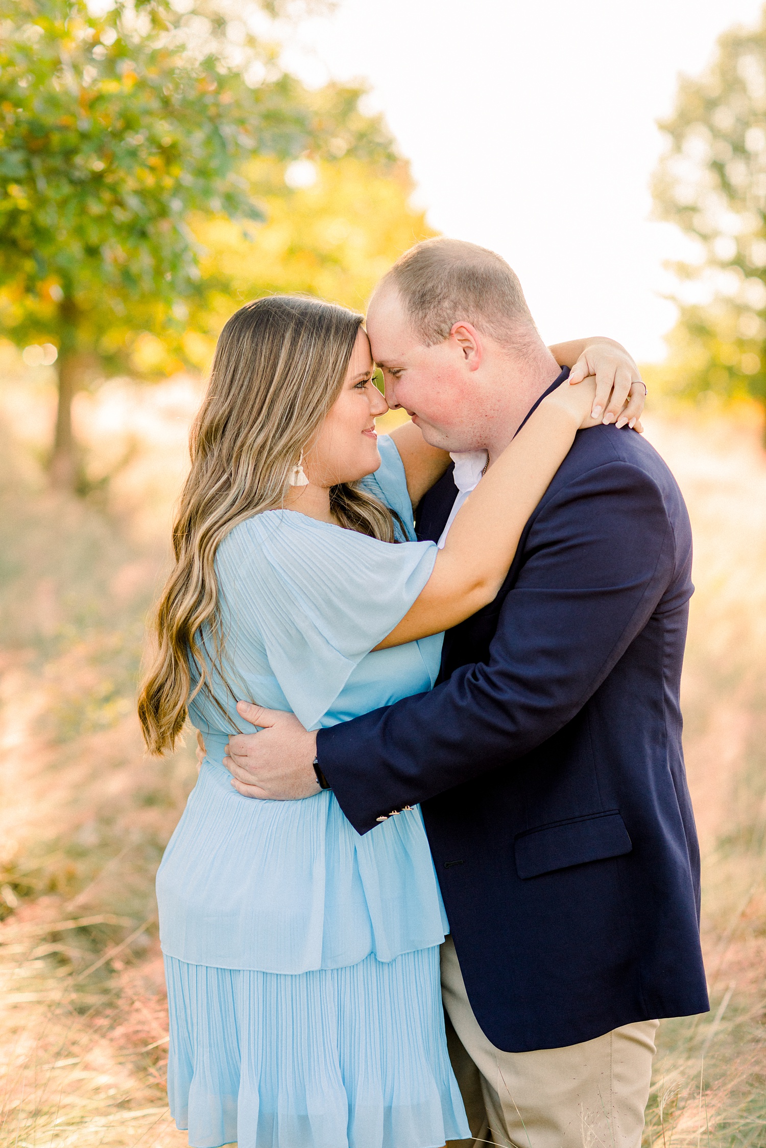 engaged couple hugs in field during Downtown Birmingham engagement session
