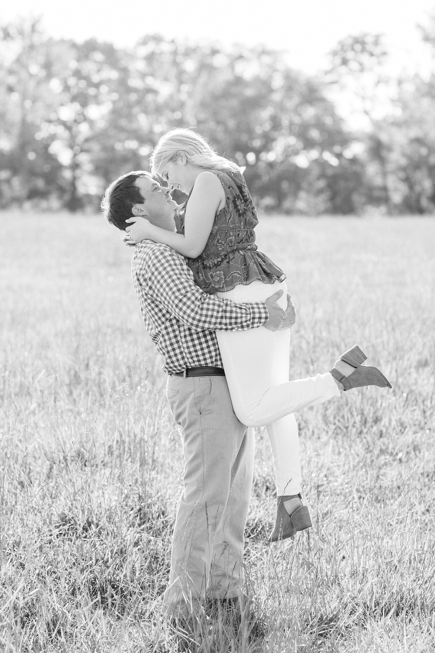 groom lifts bride up during Huntsville Alabama engagement session