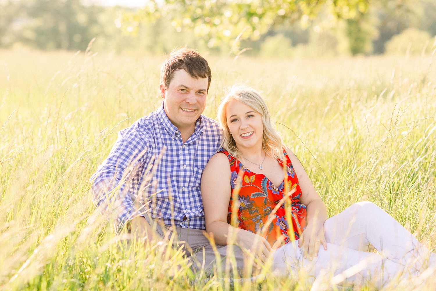 engaged couple poses in field during Huntsville Alabama engagement session