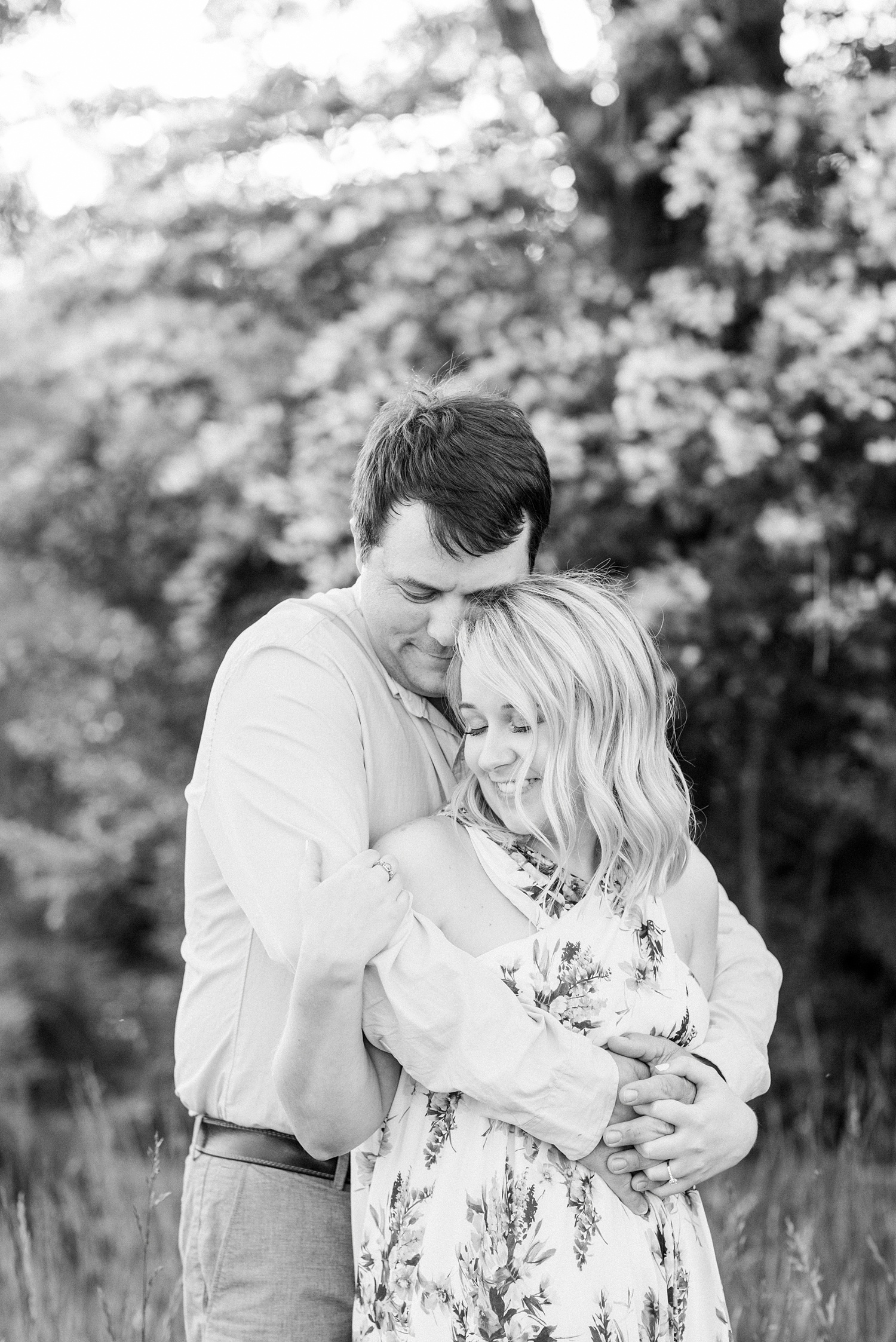 bride and groom hug by white flowers in Huntsville Alabama