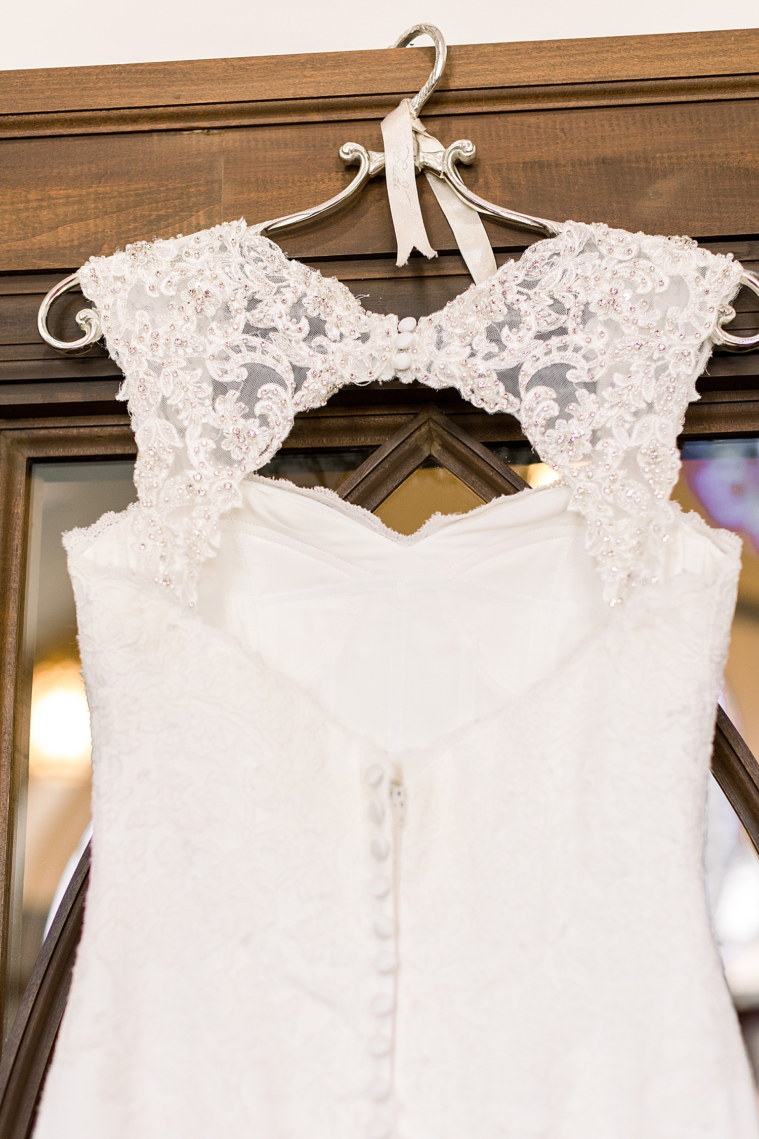 bride's wedding dress hangs in church