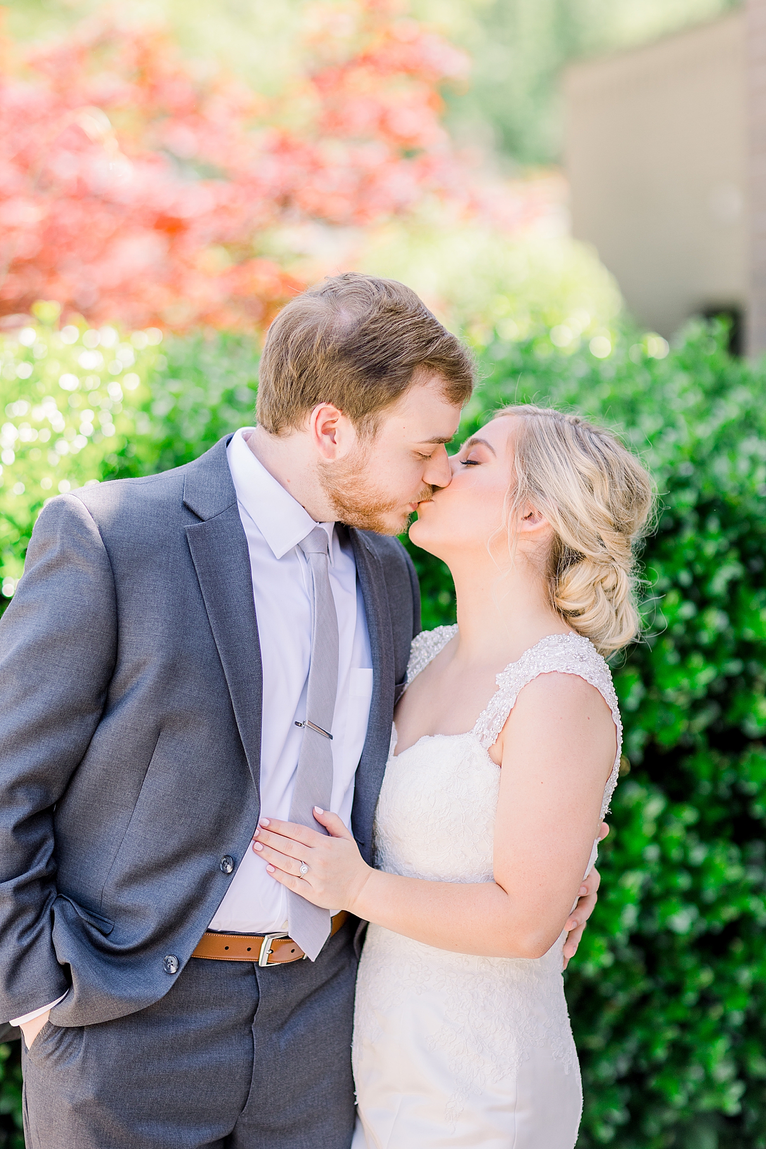 bride kisses groom during spring wedding photos in Alabama