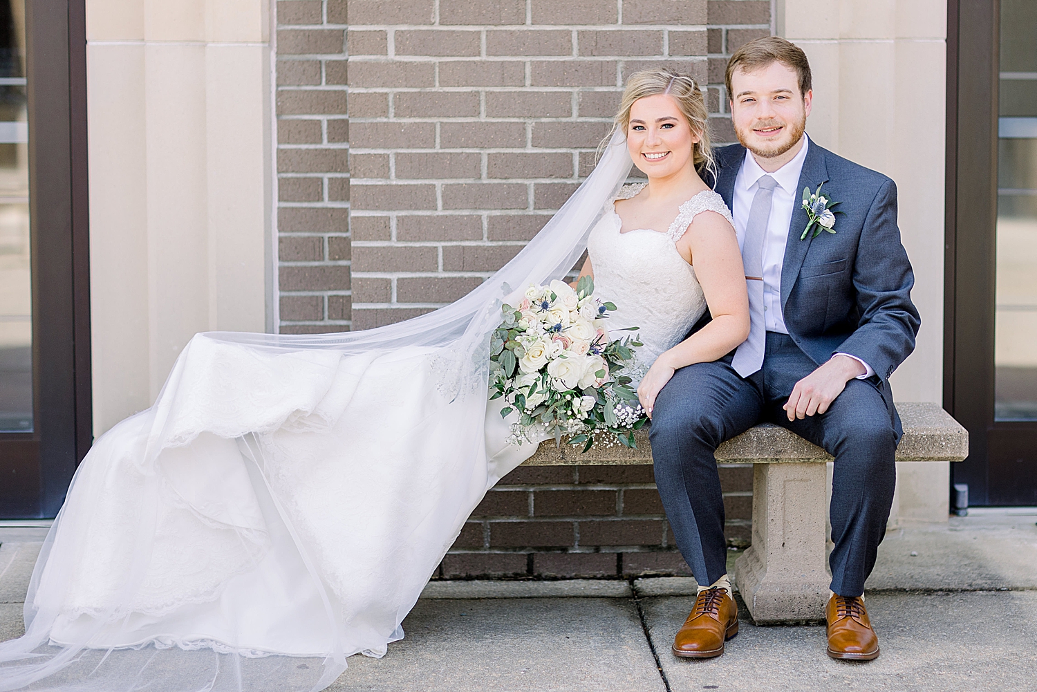 bride leans on groom's side outside church in Alabama