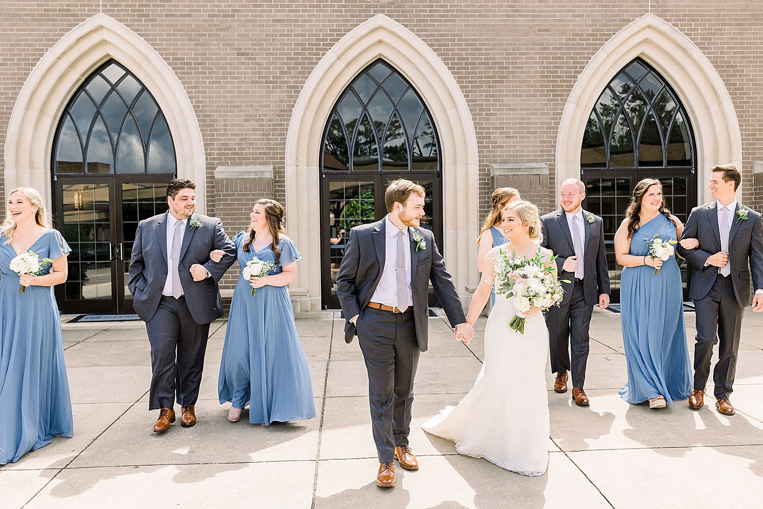 newlyweds walk with bridal party in Alabama