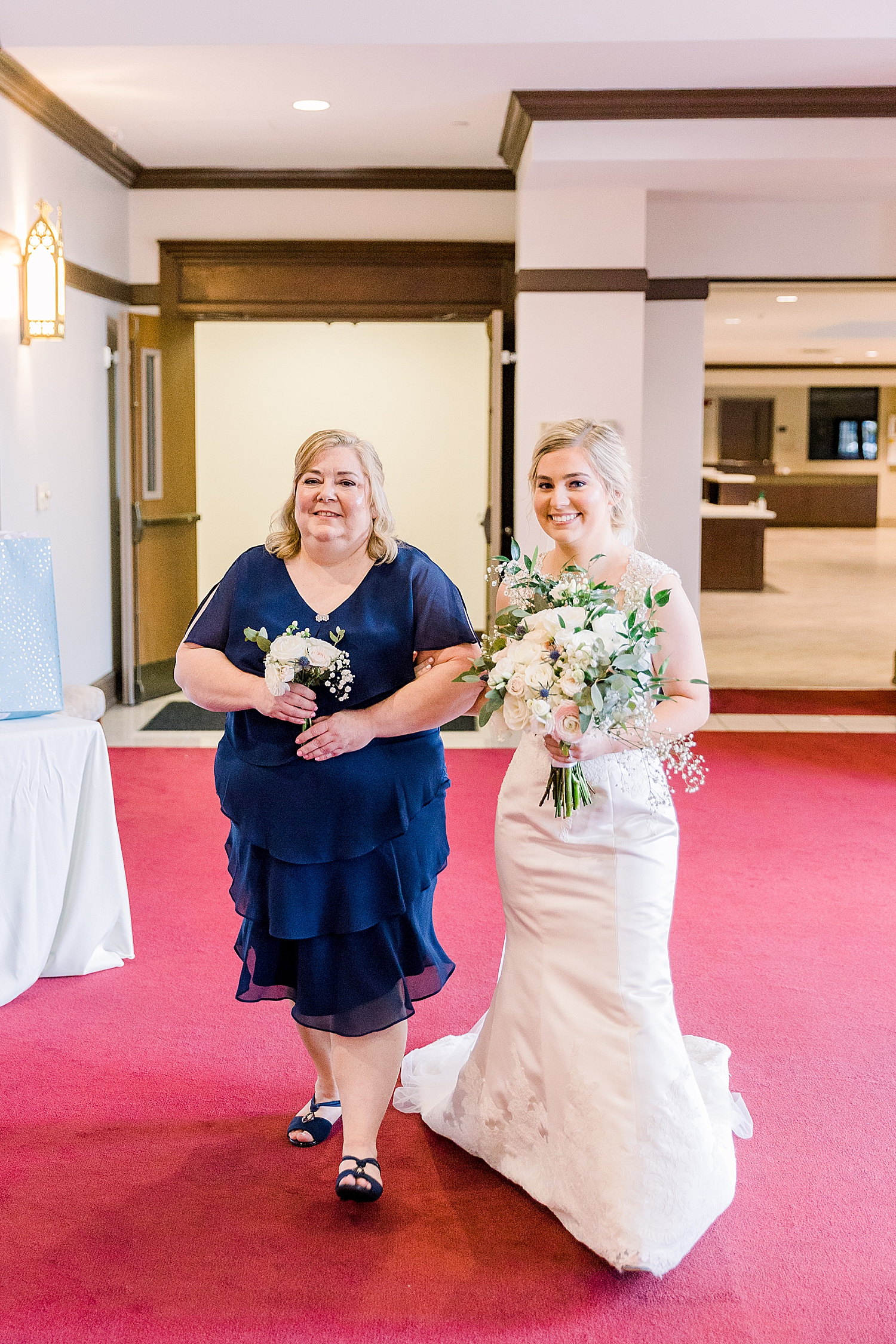 mother walks bride down aisle during traditional church wedding